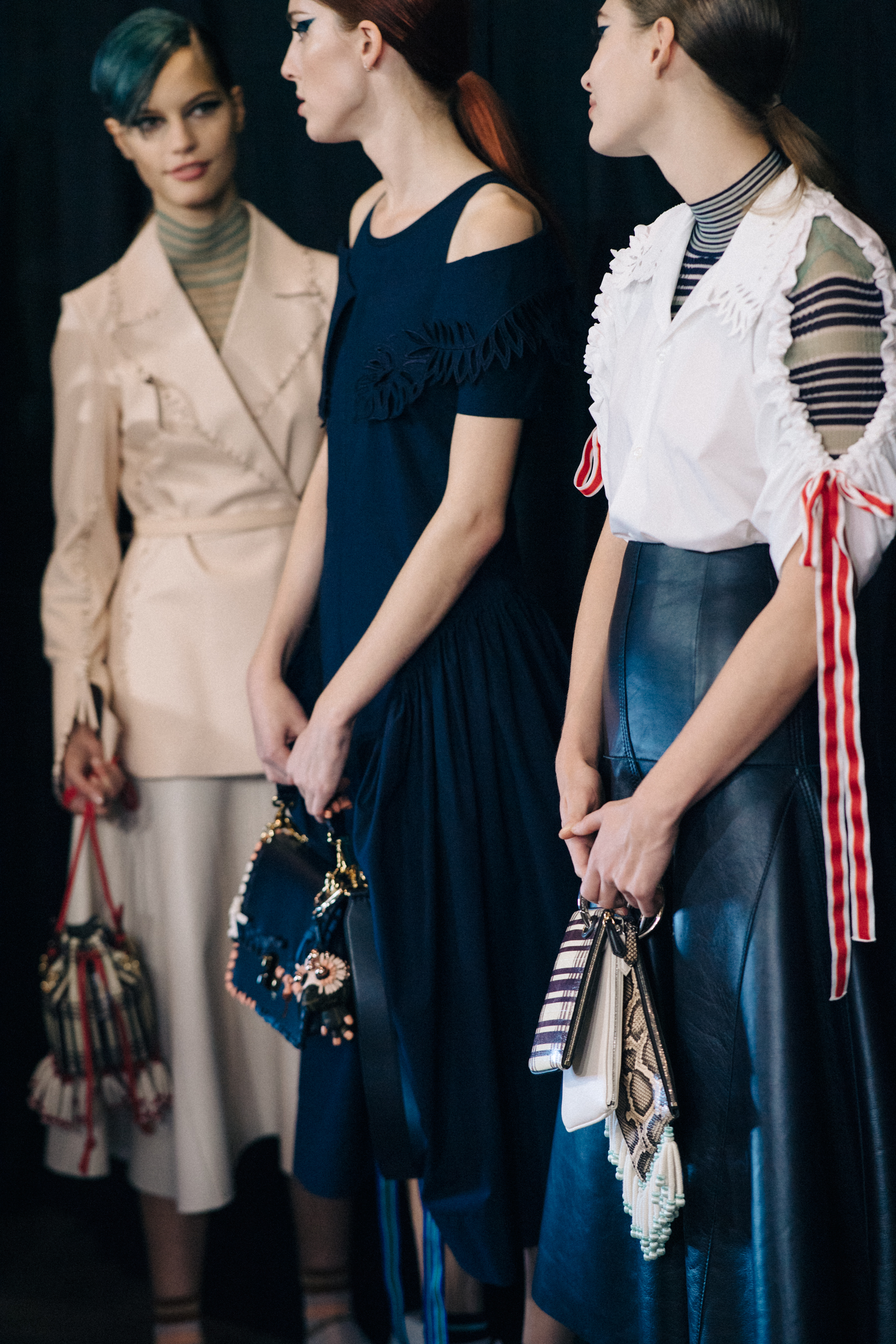 Three models backstage in Fendi outfits