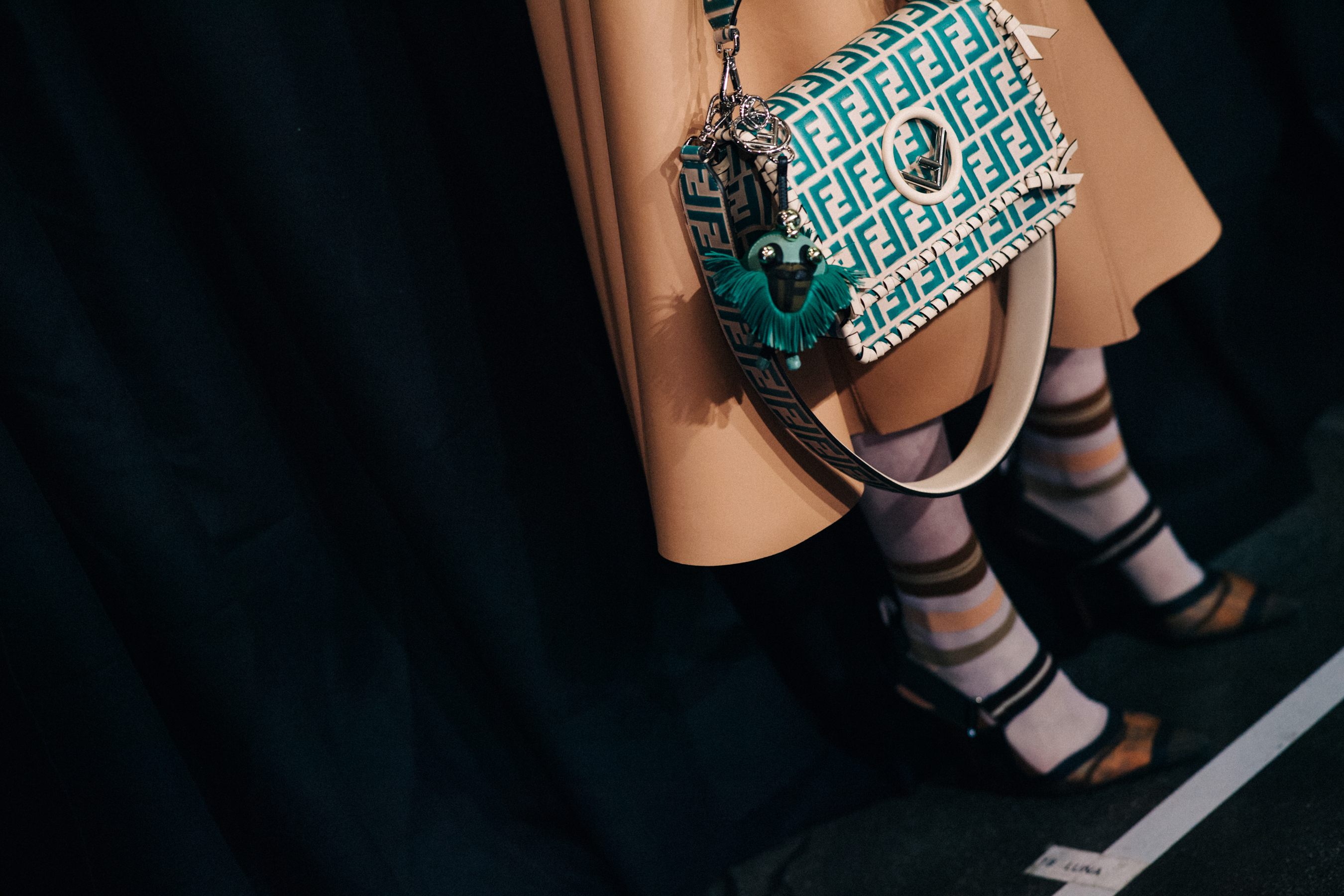 Closeup of Fendi handbag held by model