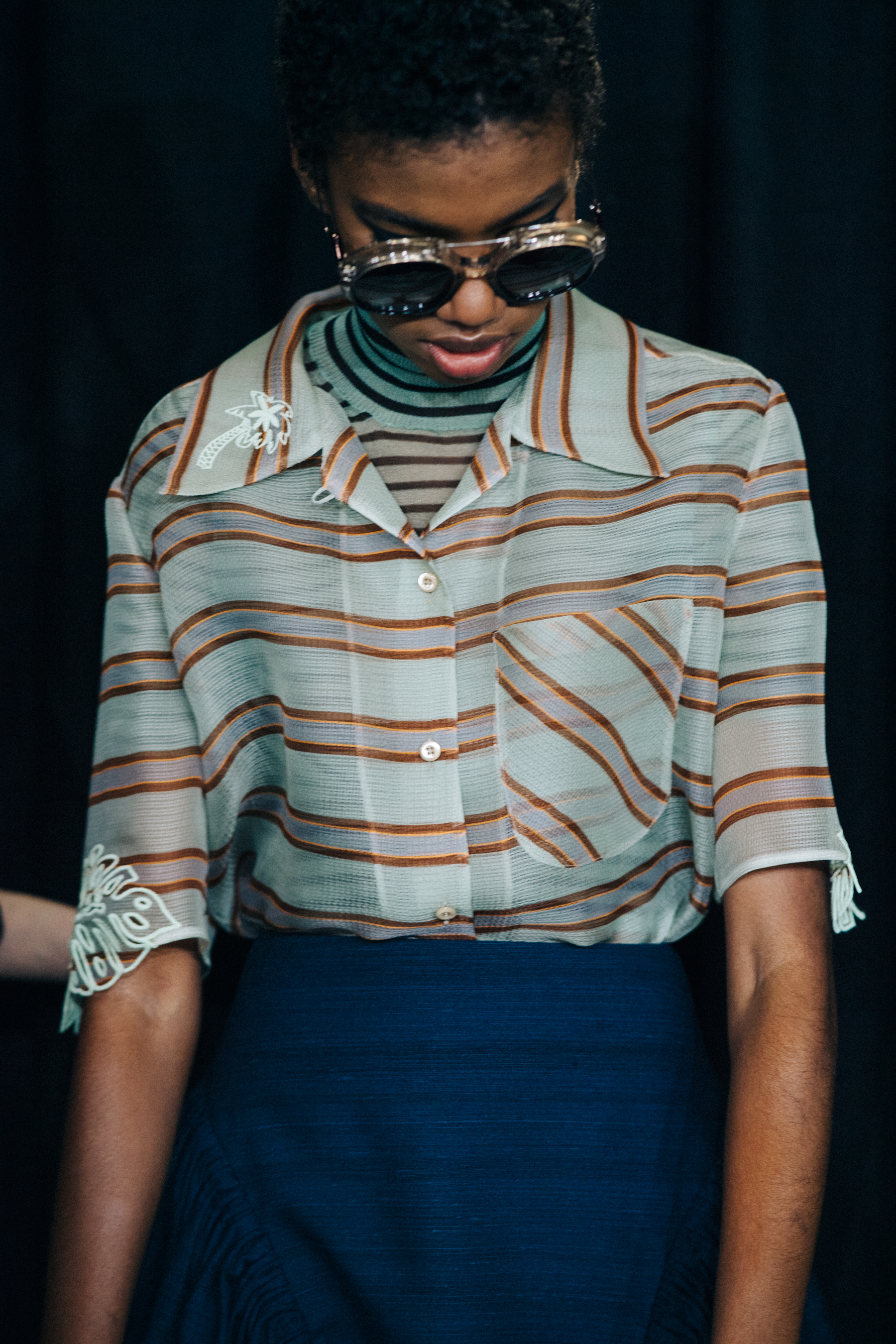 Model wearing green stripe Fendi top