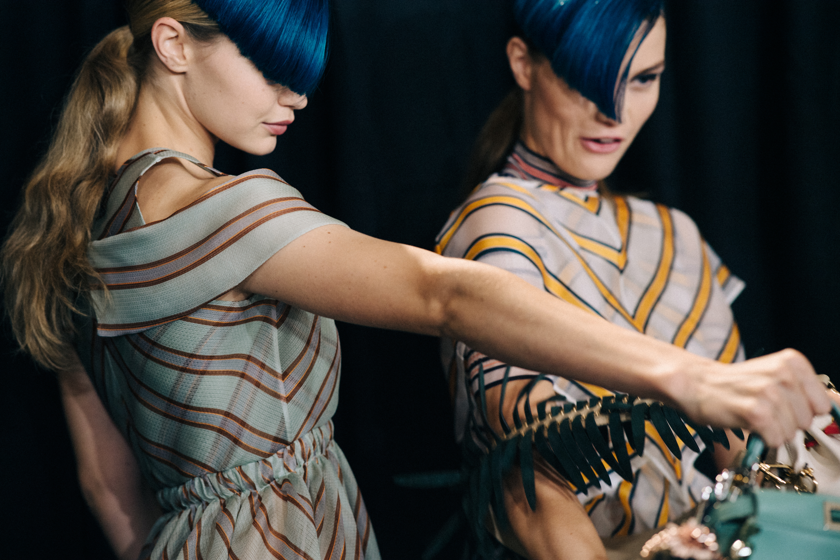 Models backstage with blue fringes