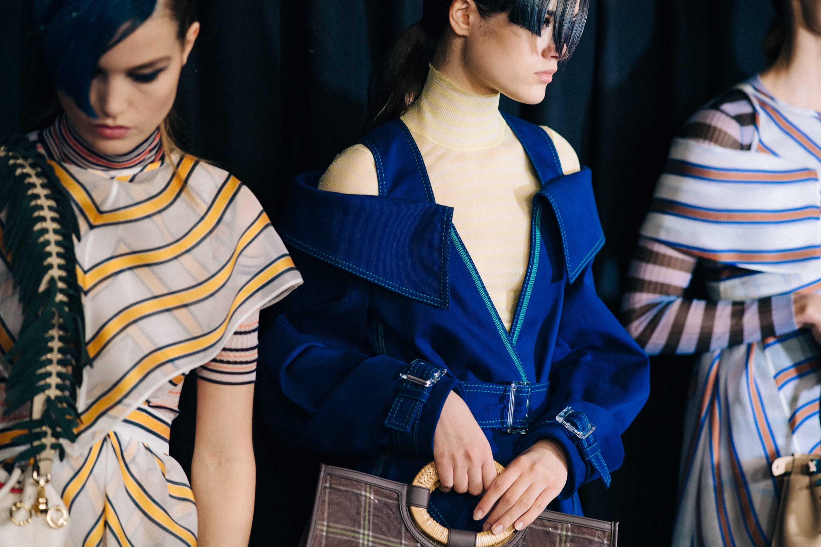 Three models backstage in Fendi outfits