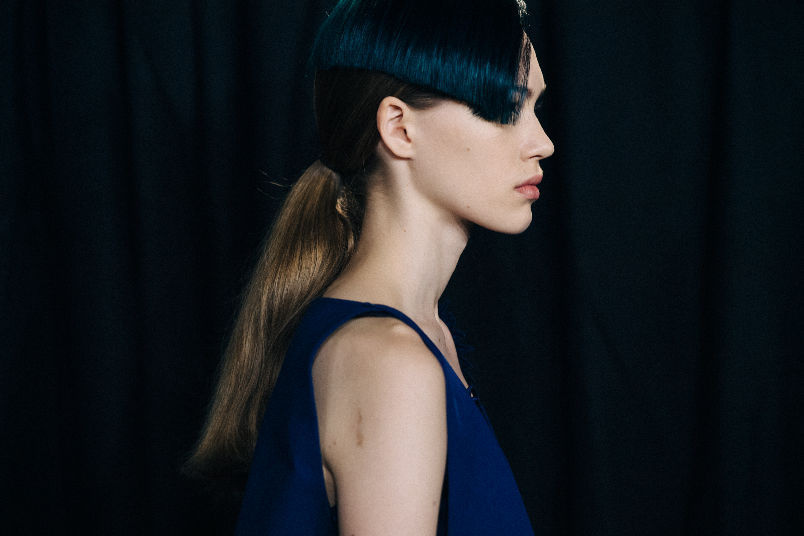Model with blue fringe and blue shirt