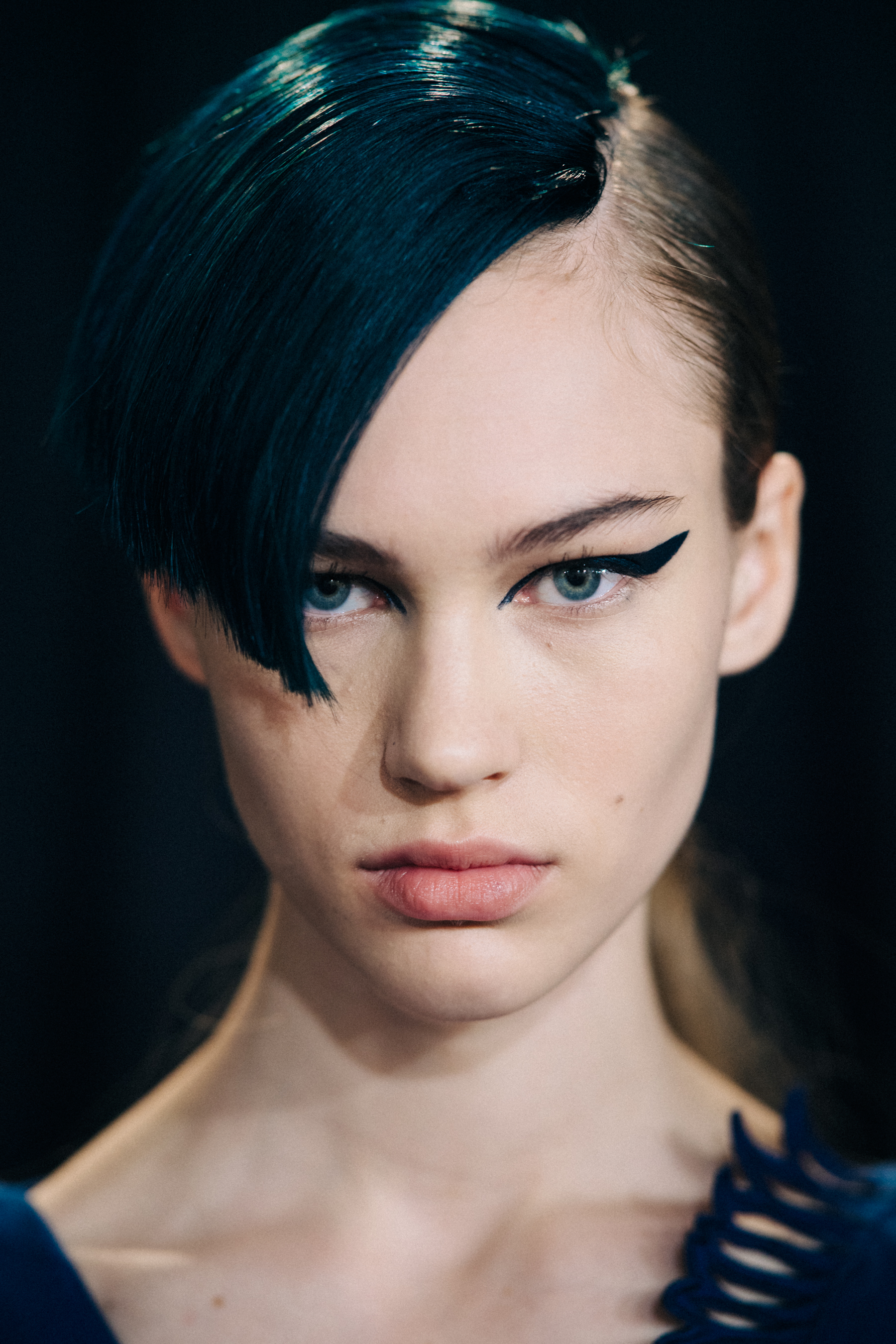 Portrait of model with blue eye makeup and blue hair