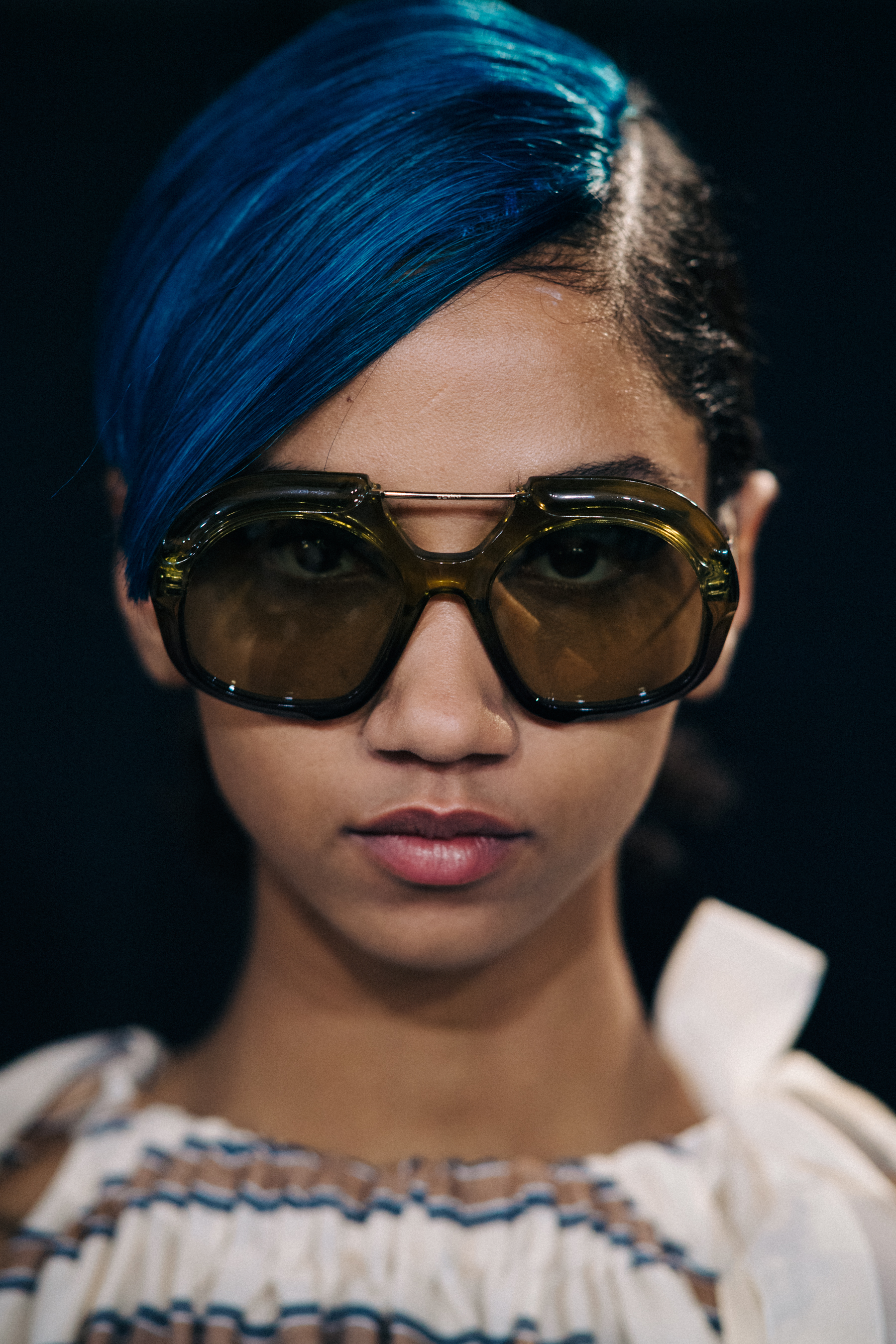 Portrait of model with blue fringe and glasses