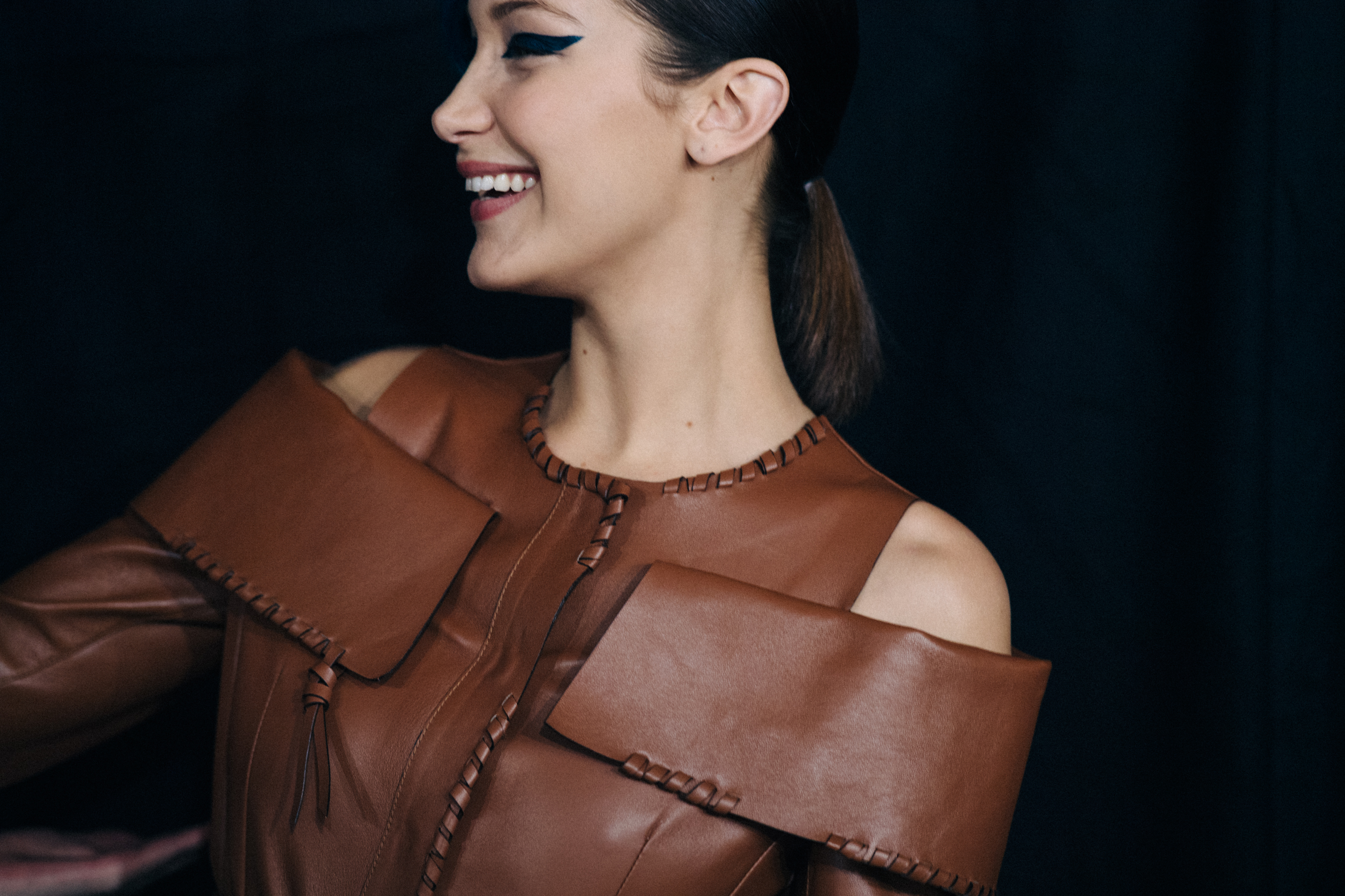 Model backstage in brown leather