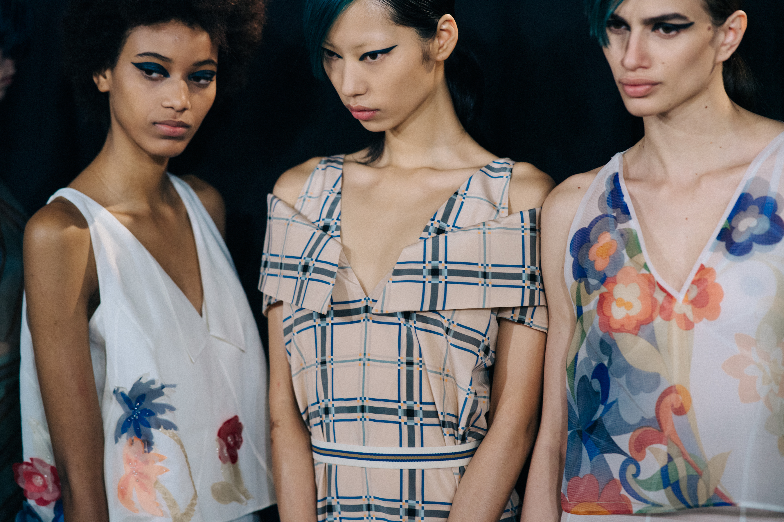 Three models backstage in Fendi outfits