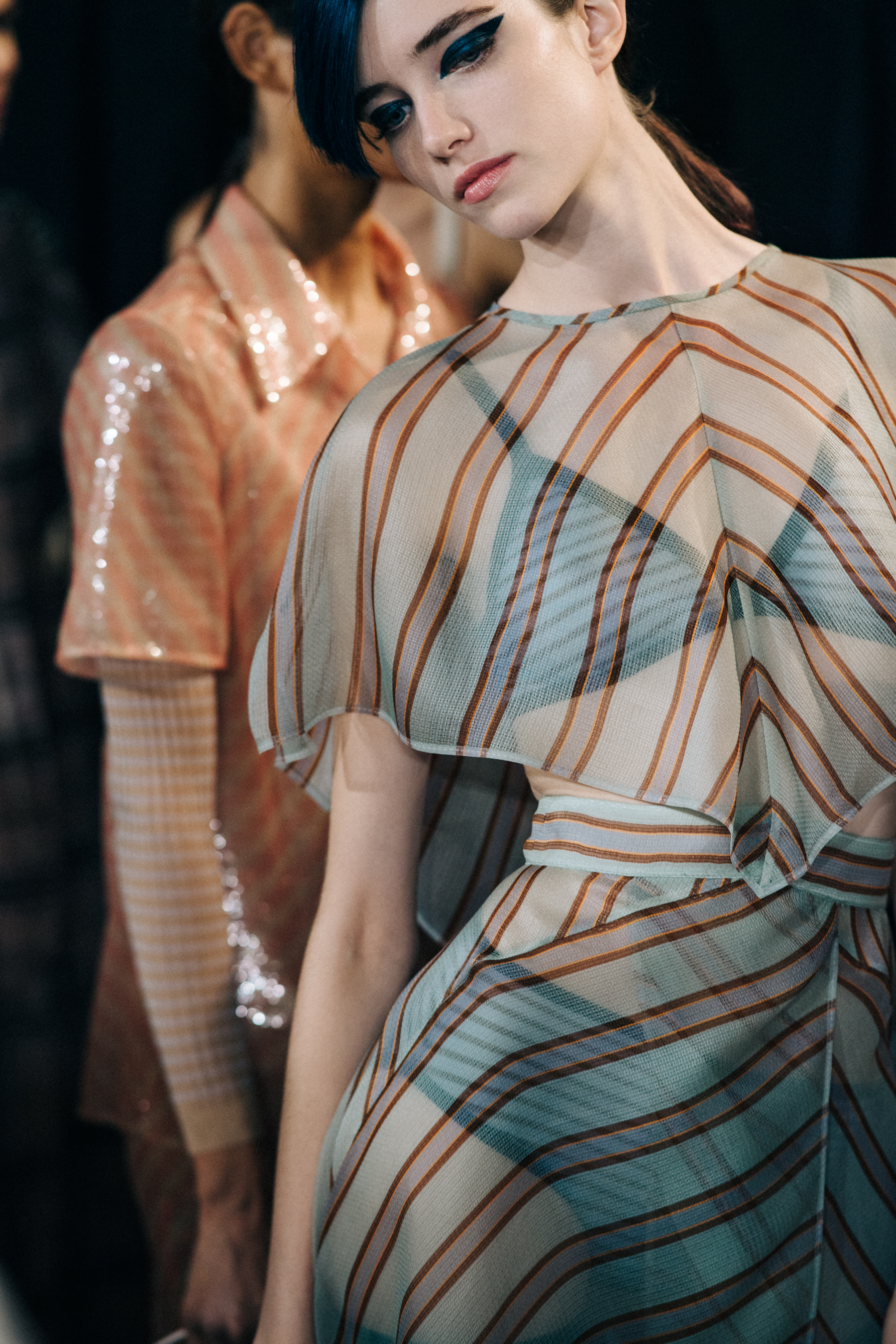 Model posing in striped outfit