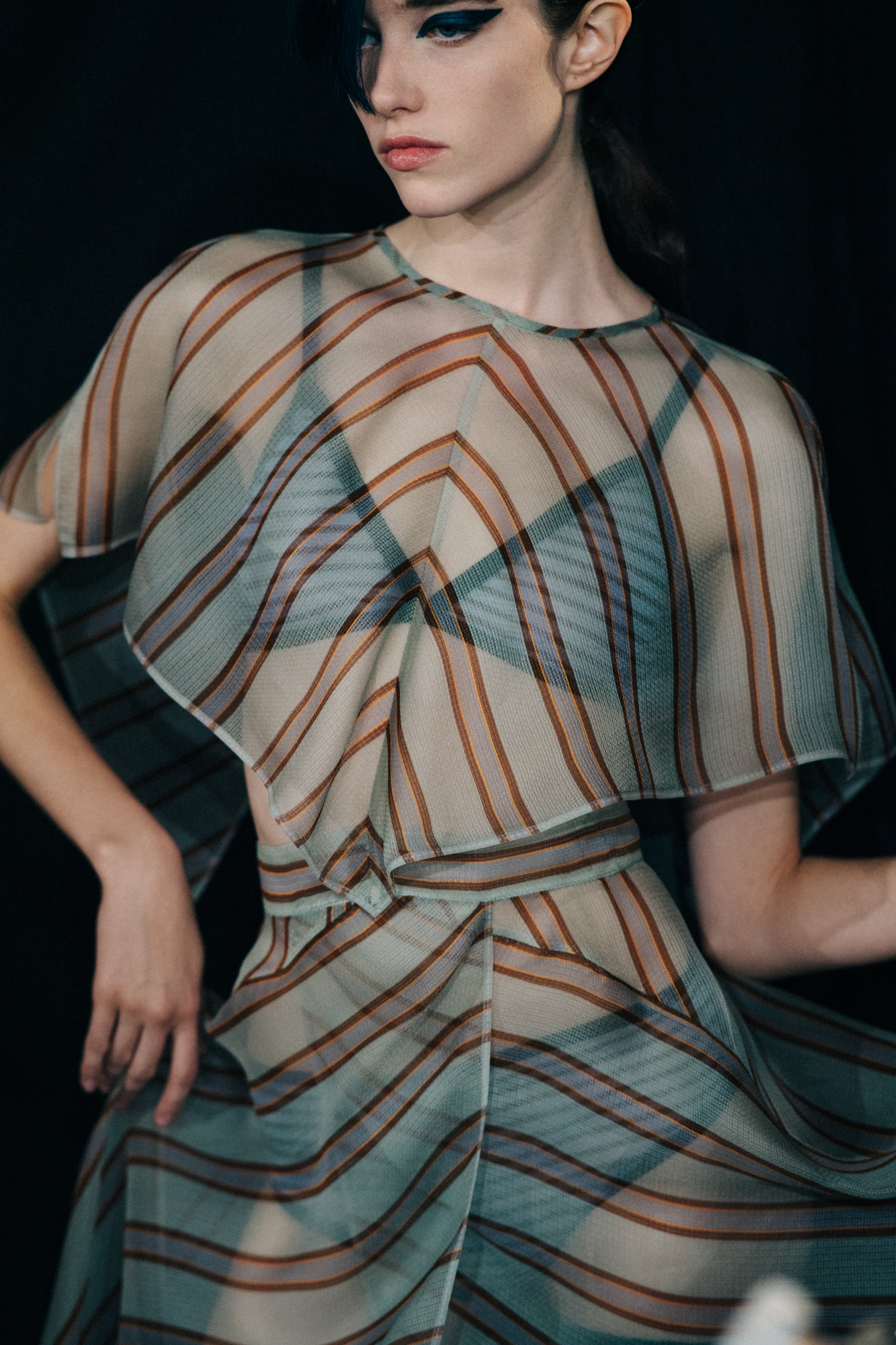 Model wearing striped outfit dancing