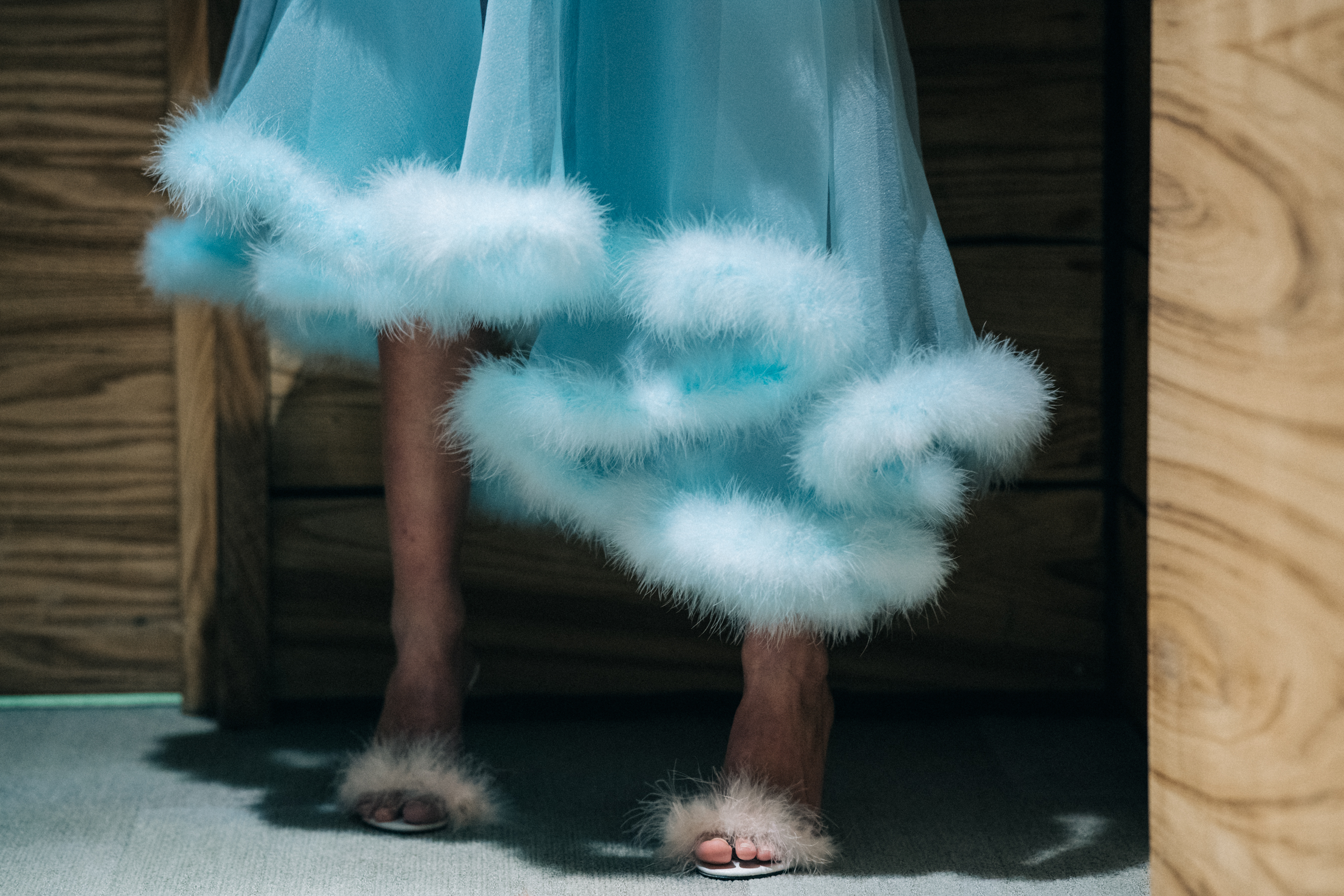Model wearing blue fur skirt