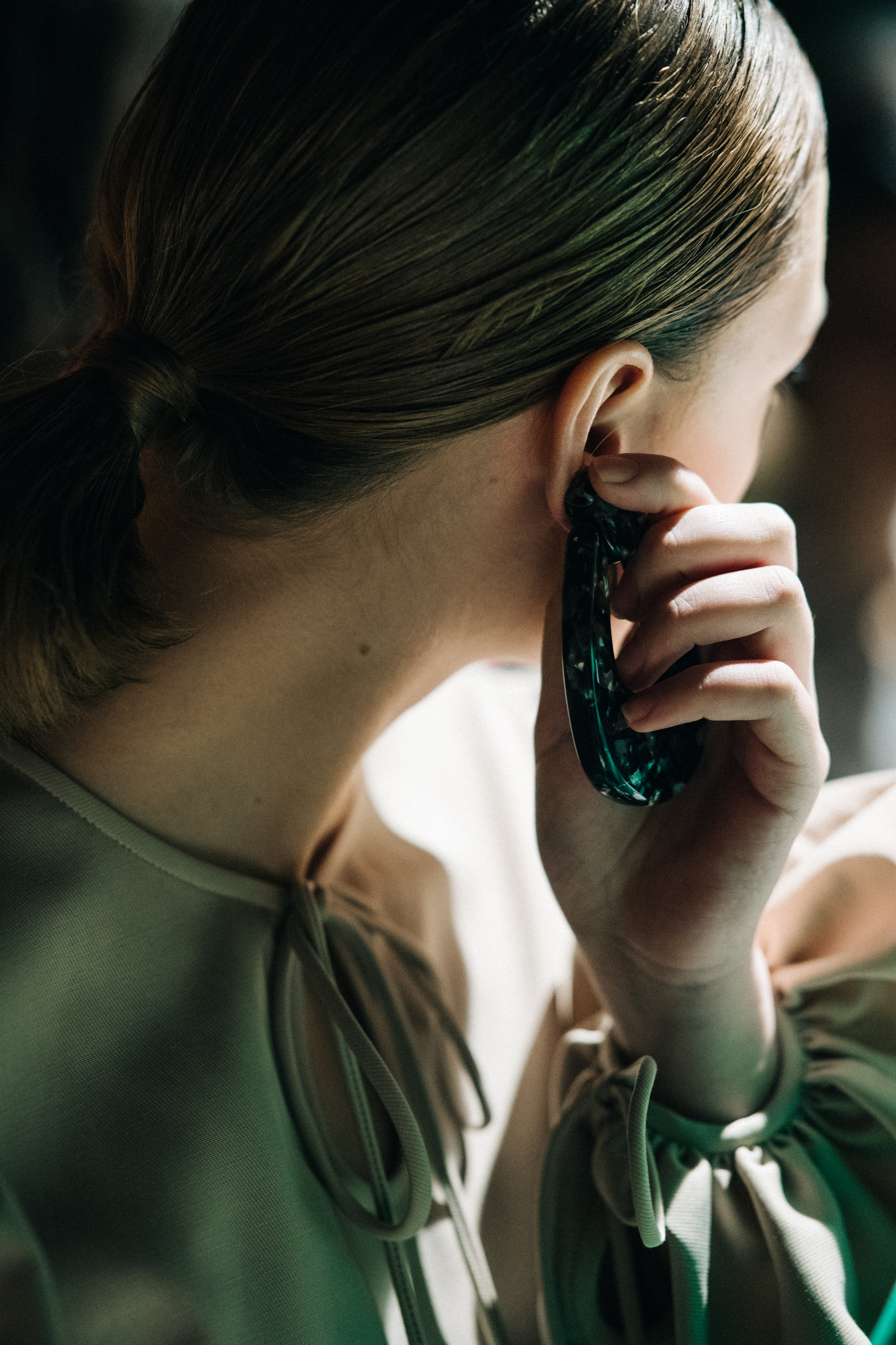 Model fixing own earring