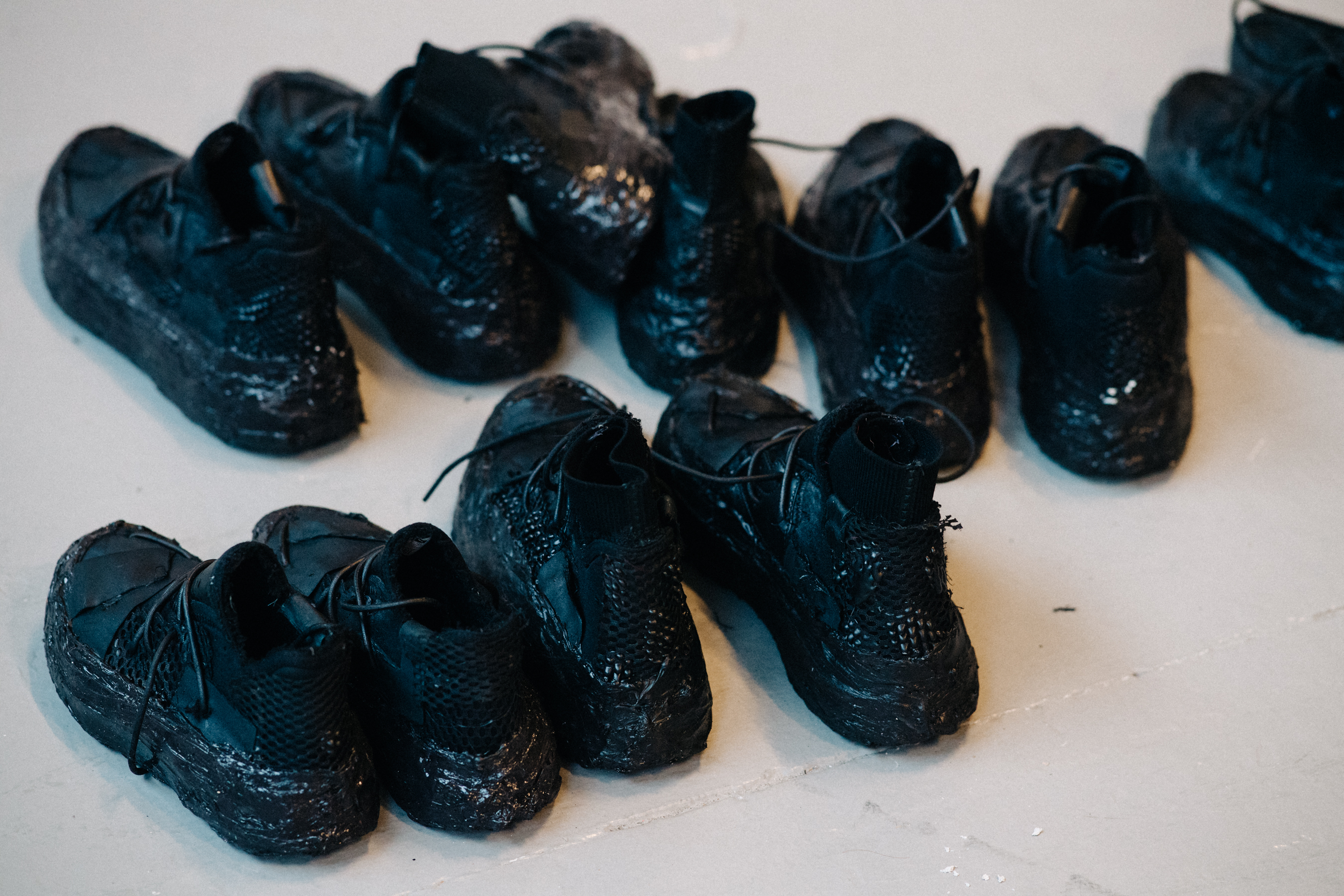 Black sneakers lined up before a show