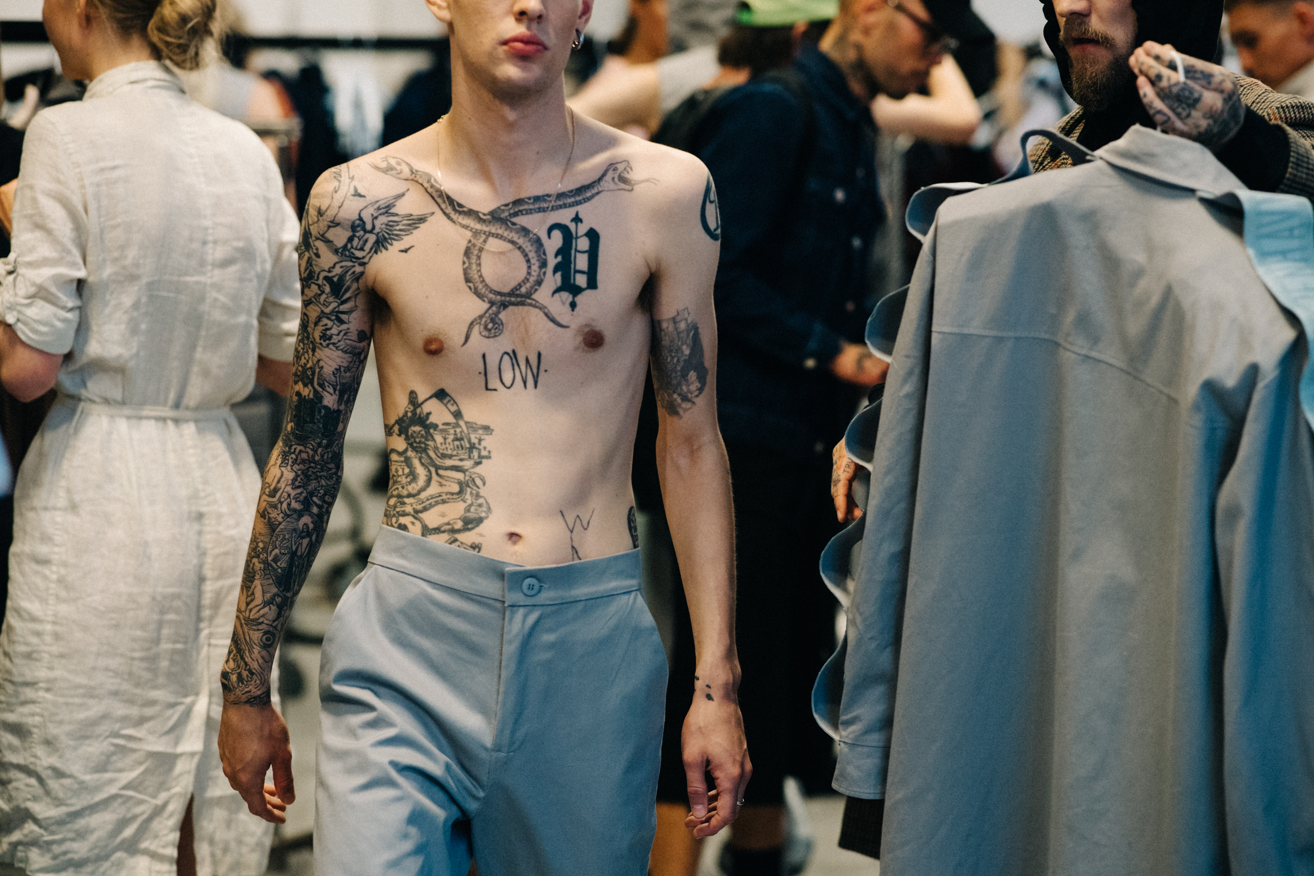 Male model with tattoos before a show