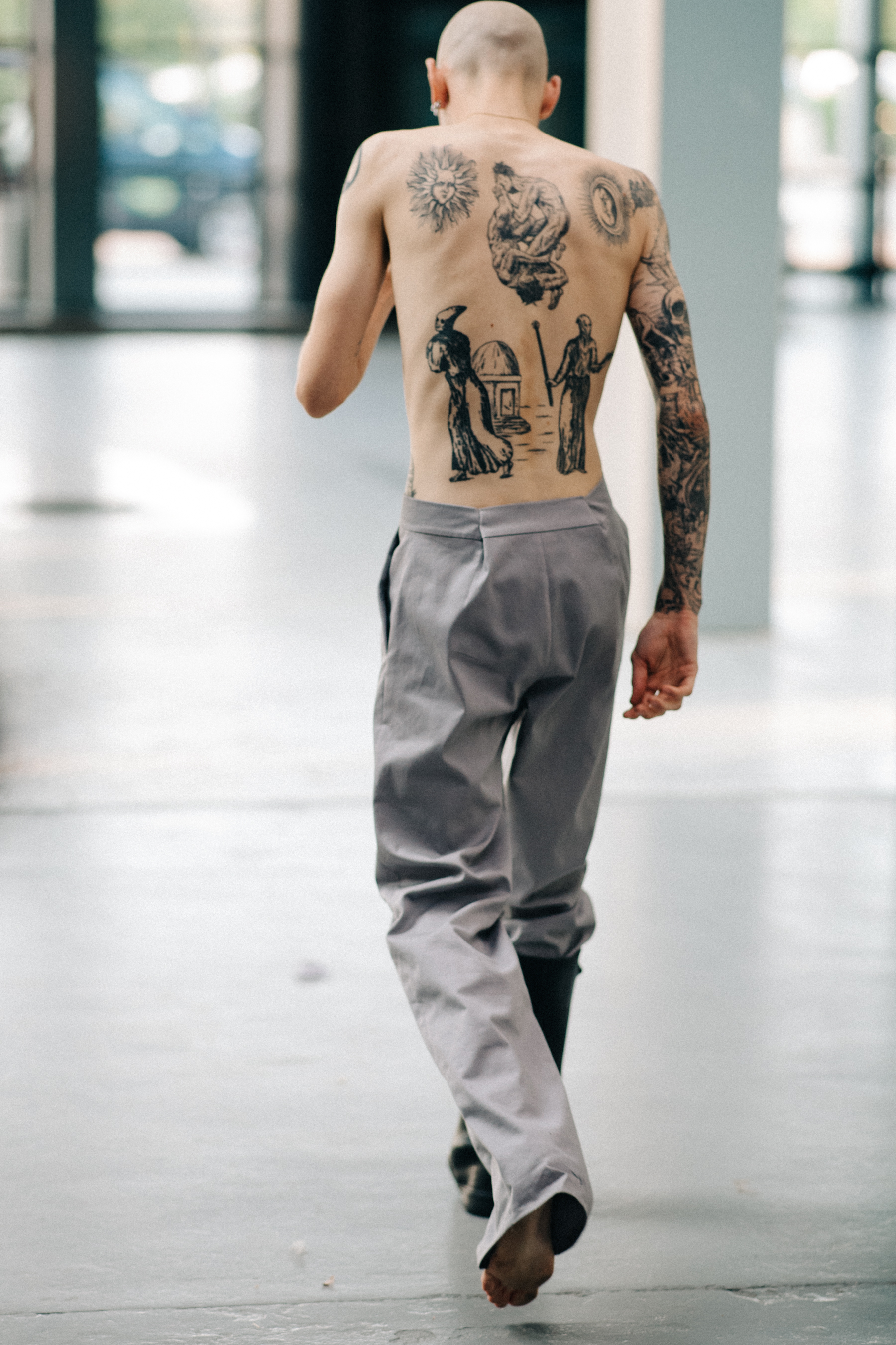 Male model with tattoos before a show