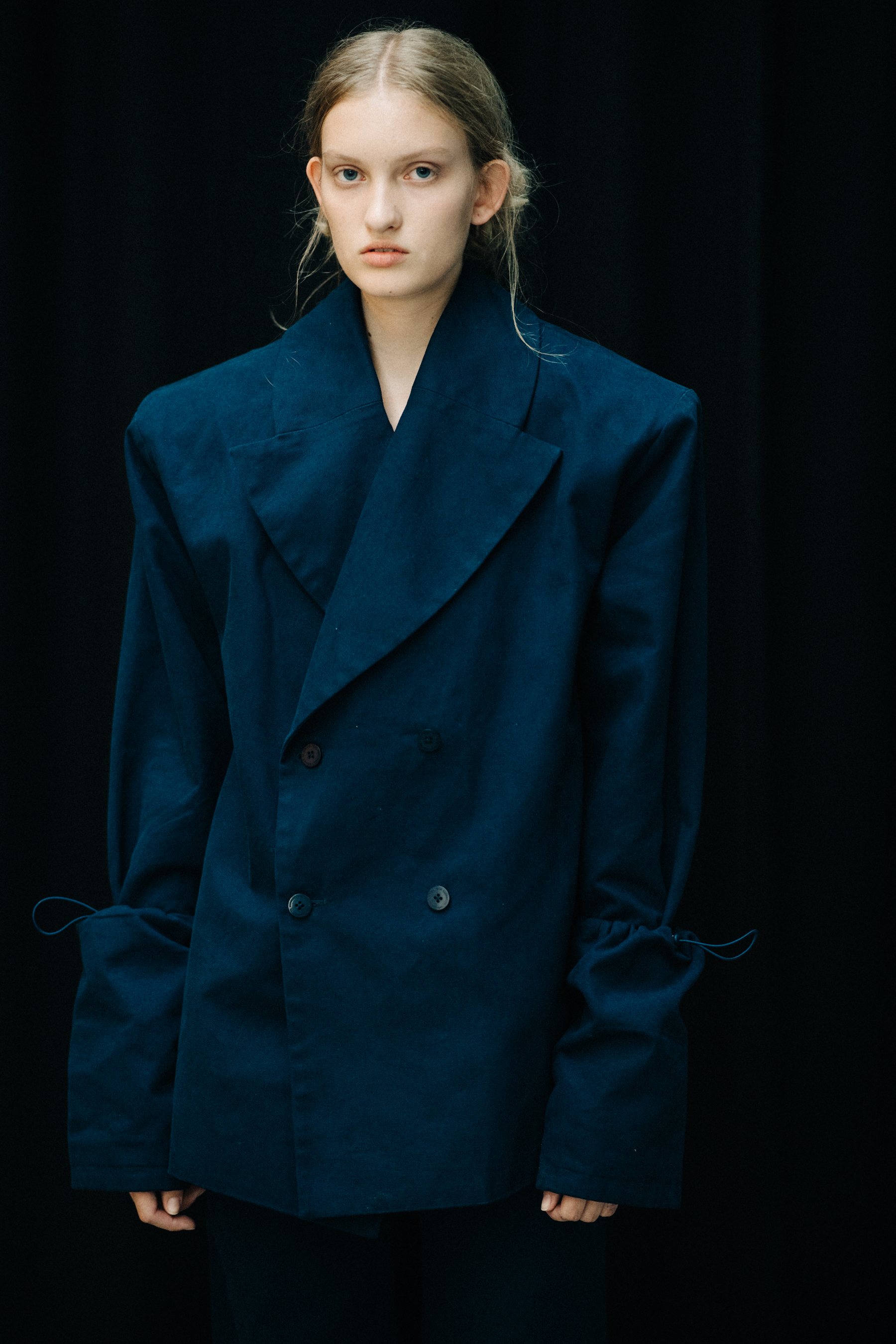 Model wearing blue jacket