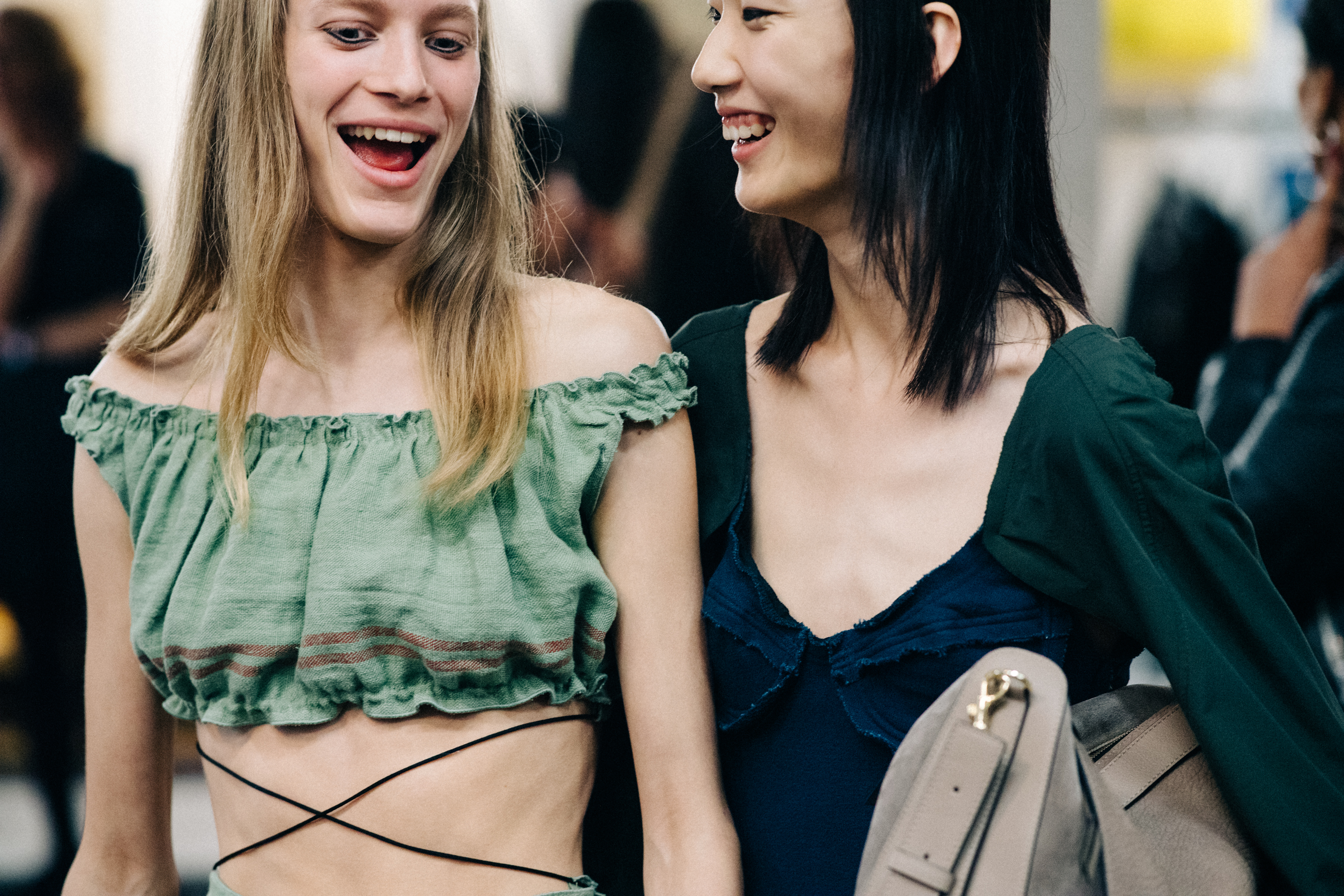 Model wearing colourful garments before a show