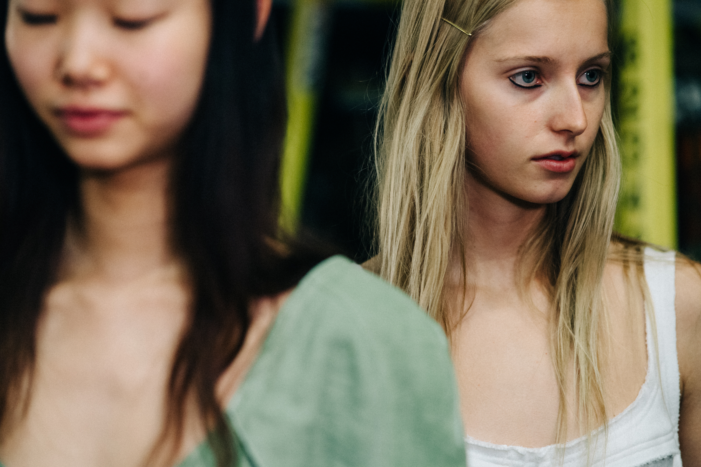 Model wearing colourful garments before a show