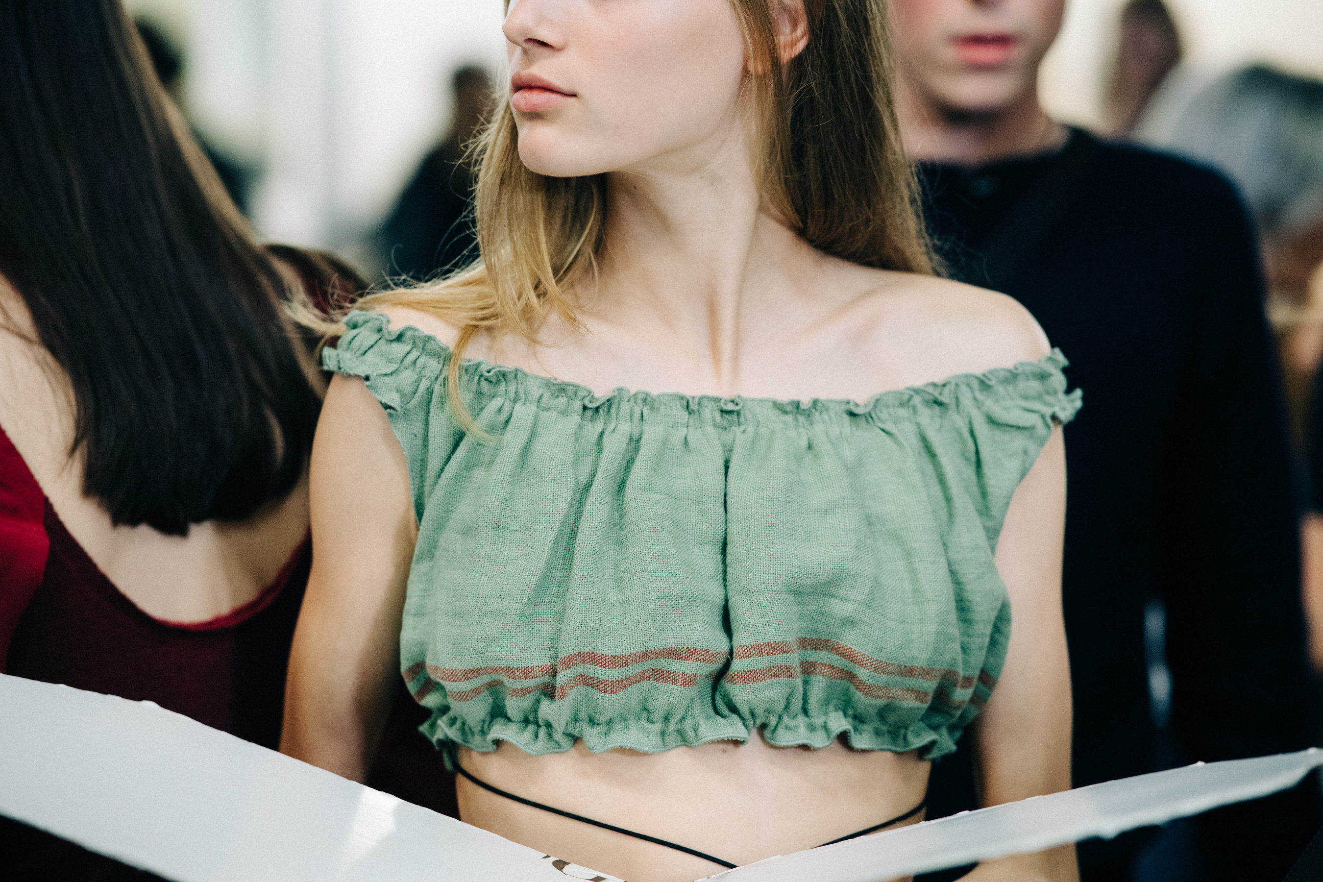 Model wearing colourful garments before a show