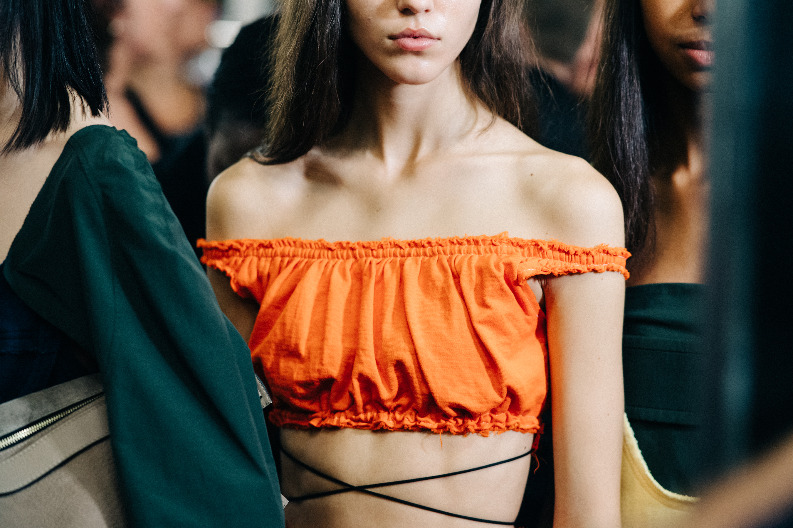 Model wearing colourful garments before a show