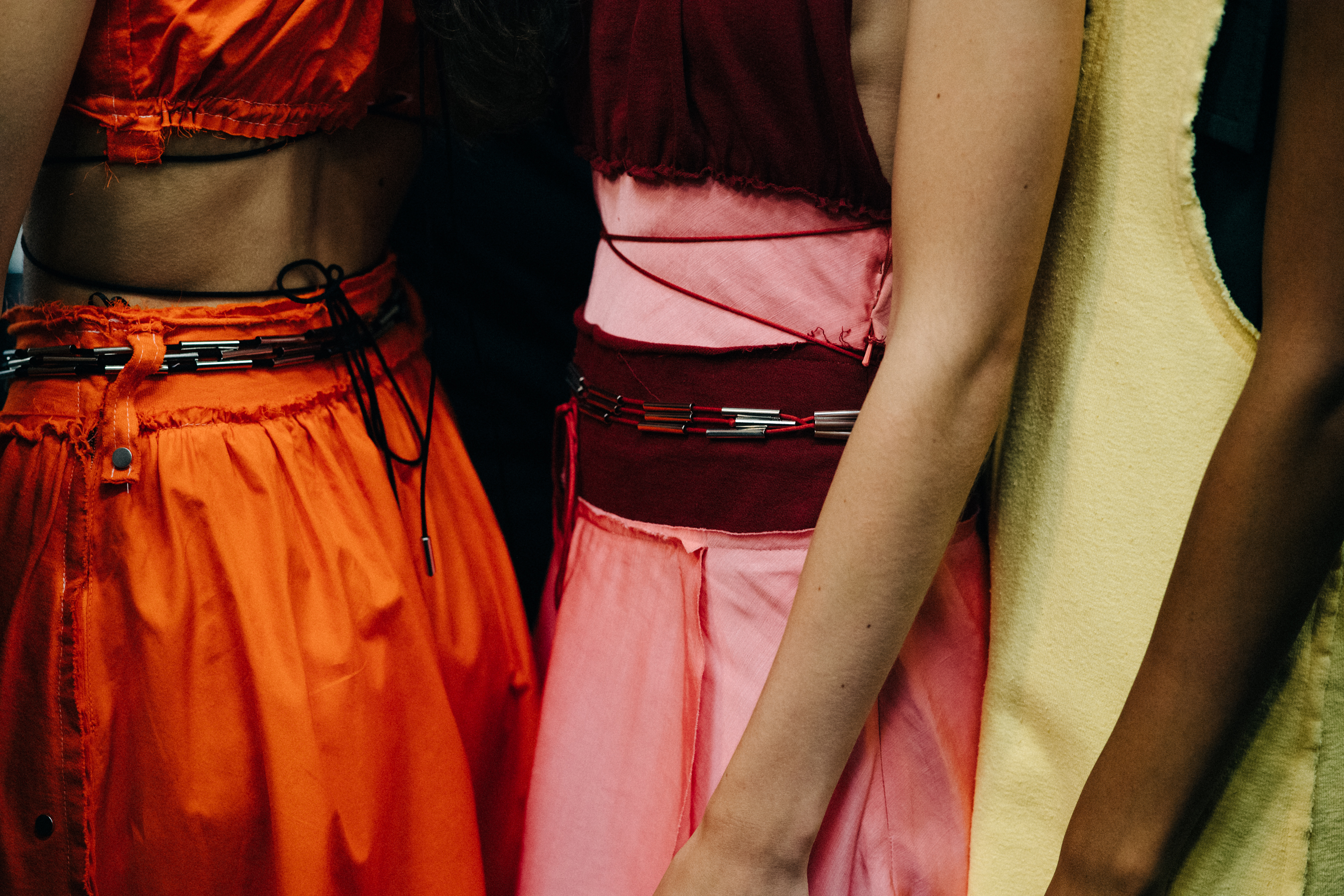 Model wearing colourful garments before a show