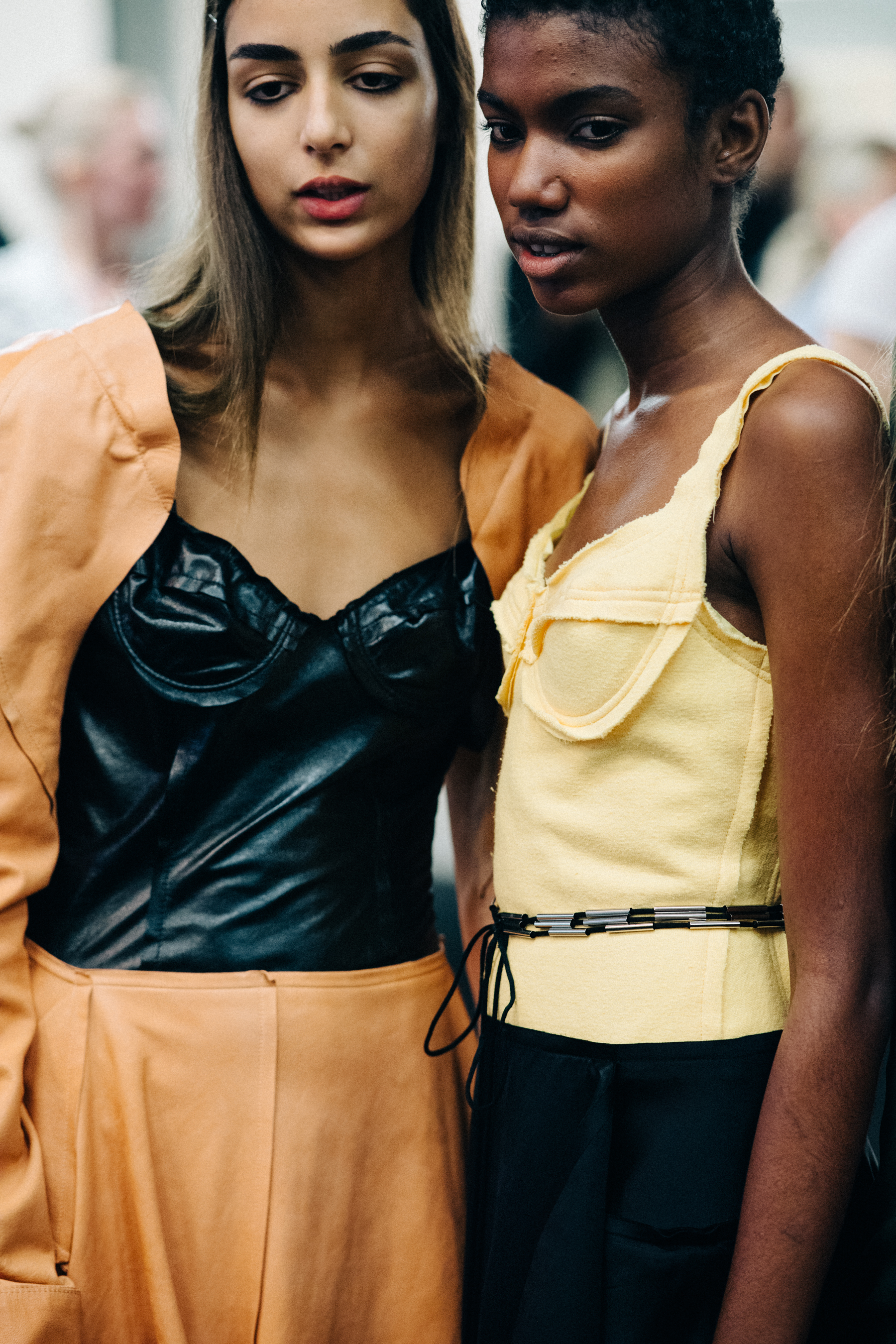 Model wearing colourful garments before a show