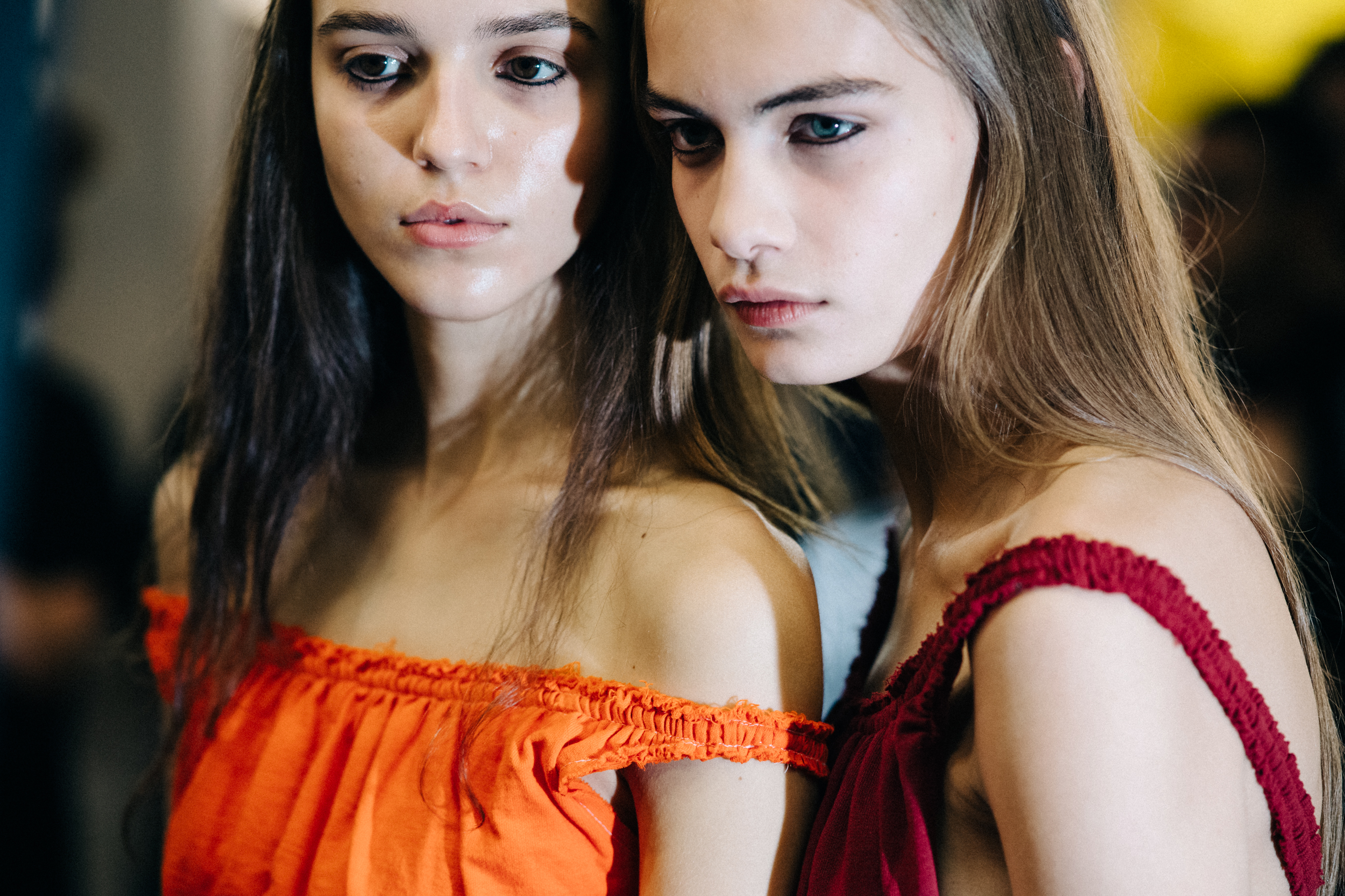 Model wearing colourful garments before a show