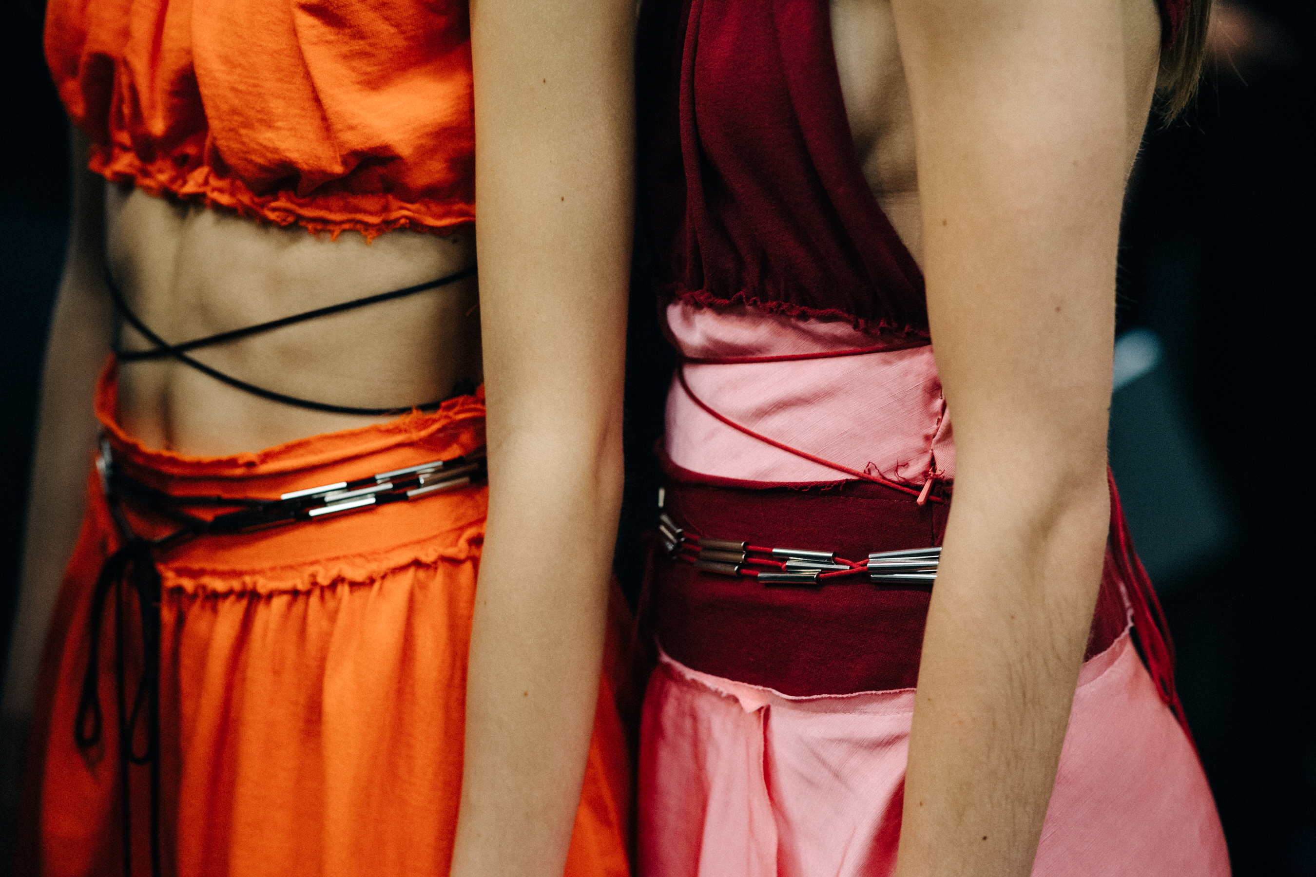 Model wearing colourful garments before a show