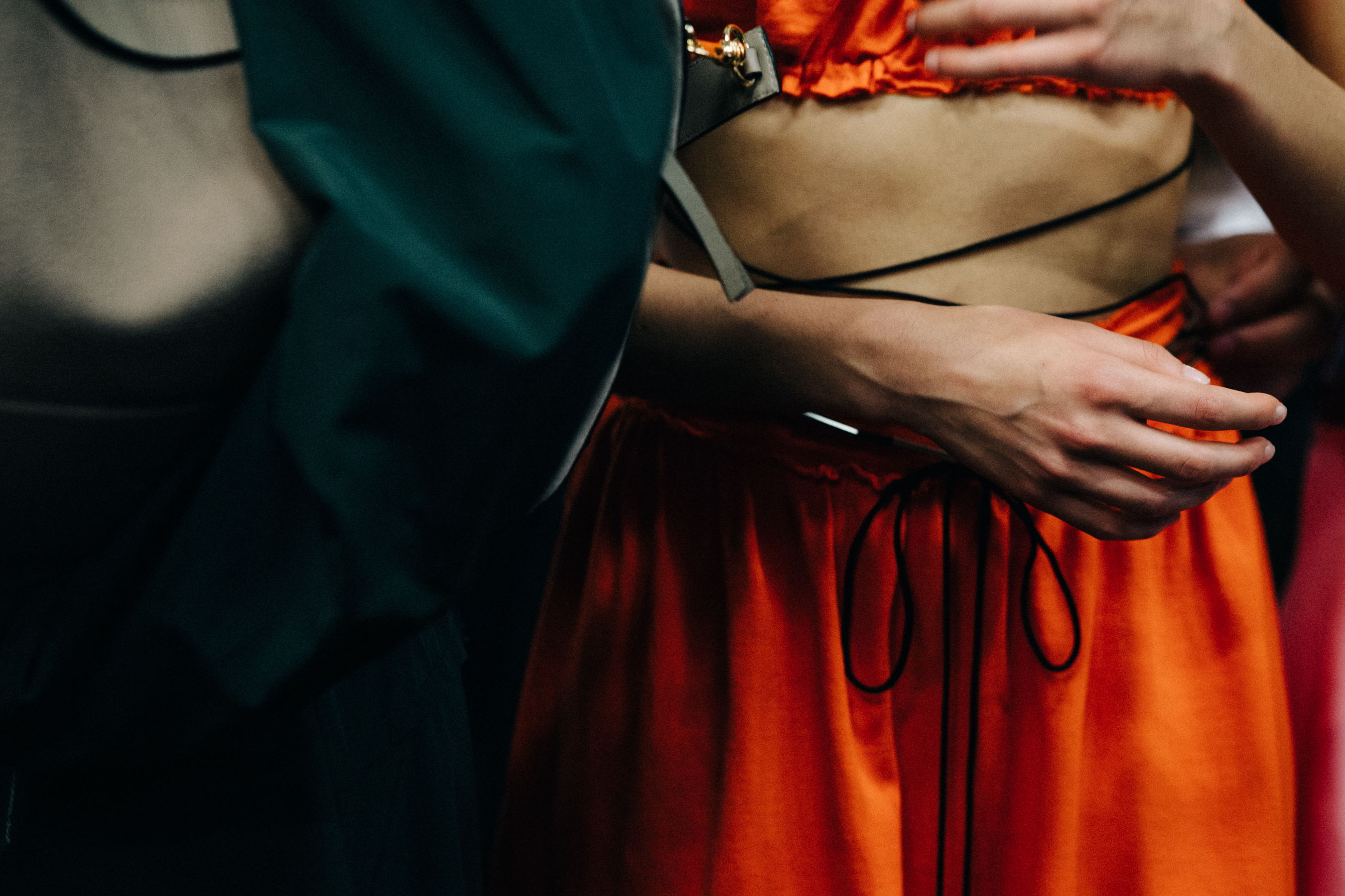 Model wearing colourful garments before a show