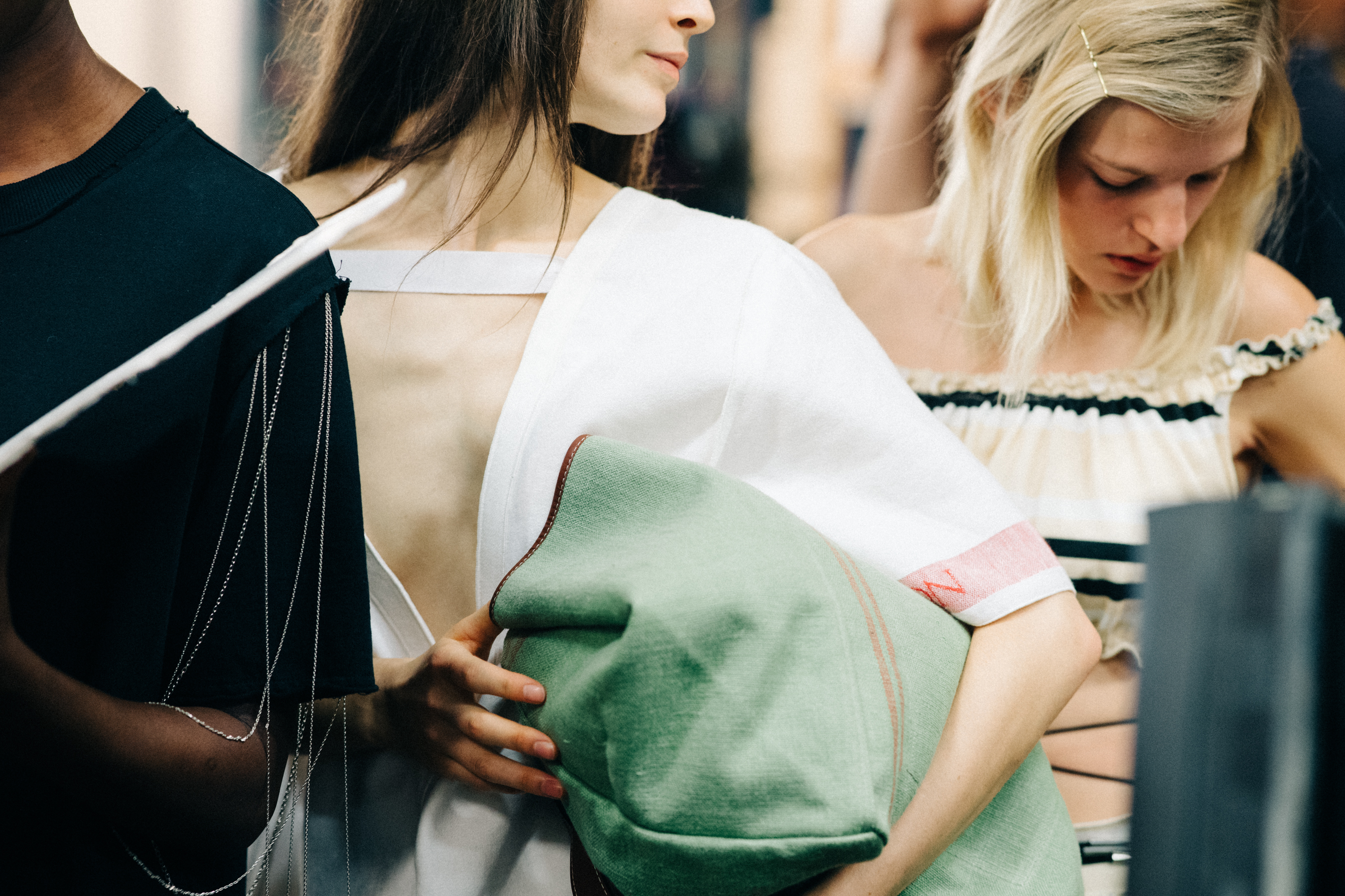 Model wearing colourful garments before a show