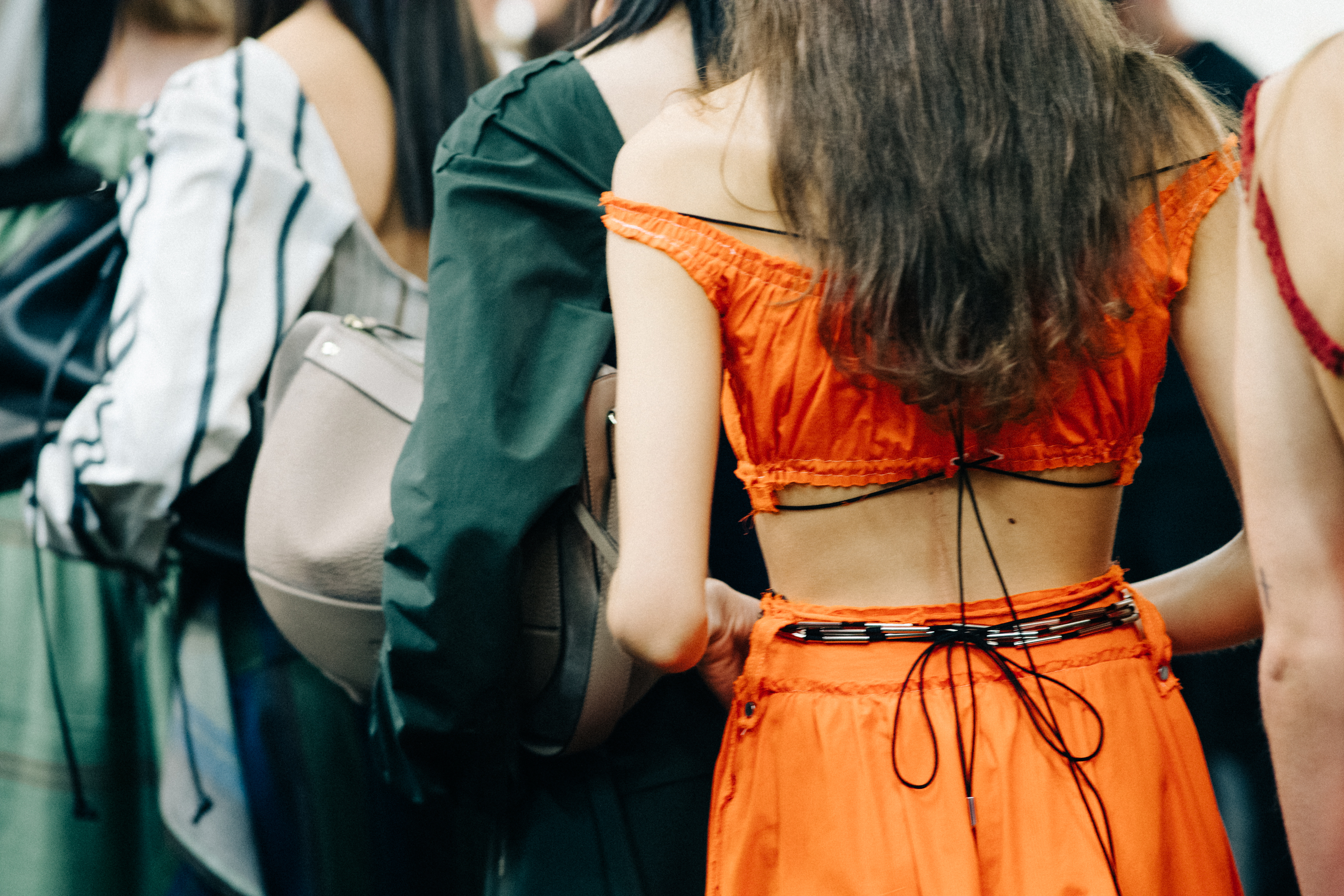 Model wearing colourful garments before a show