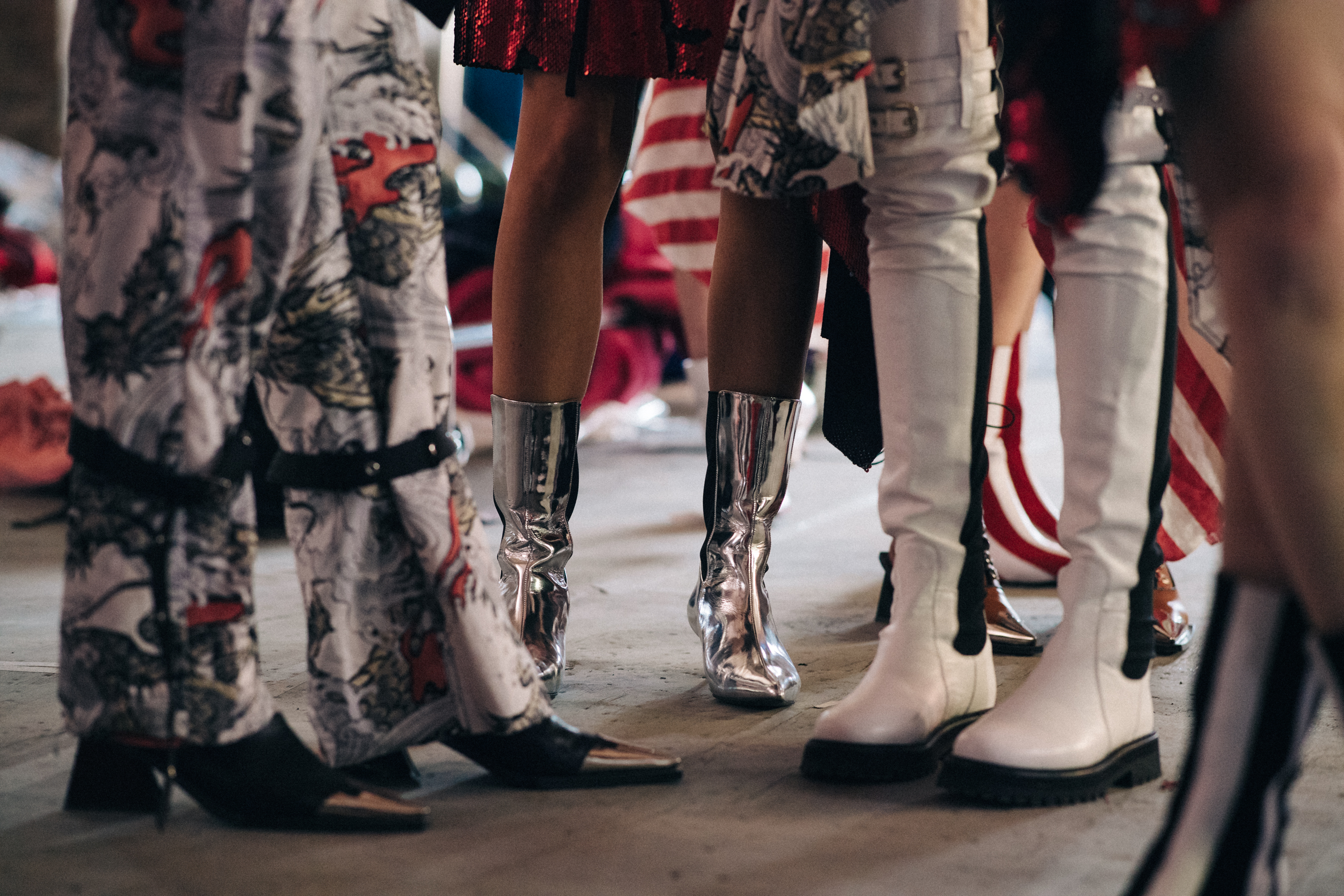Models wearing stiletto boots before a show