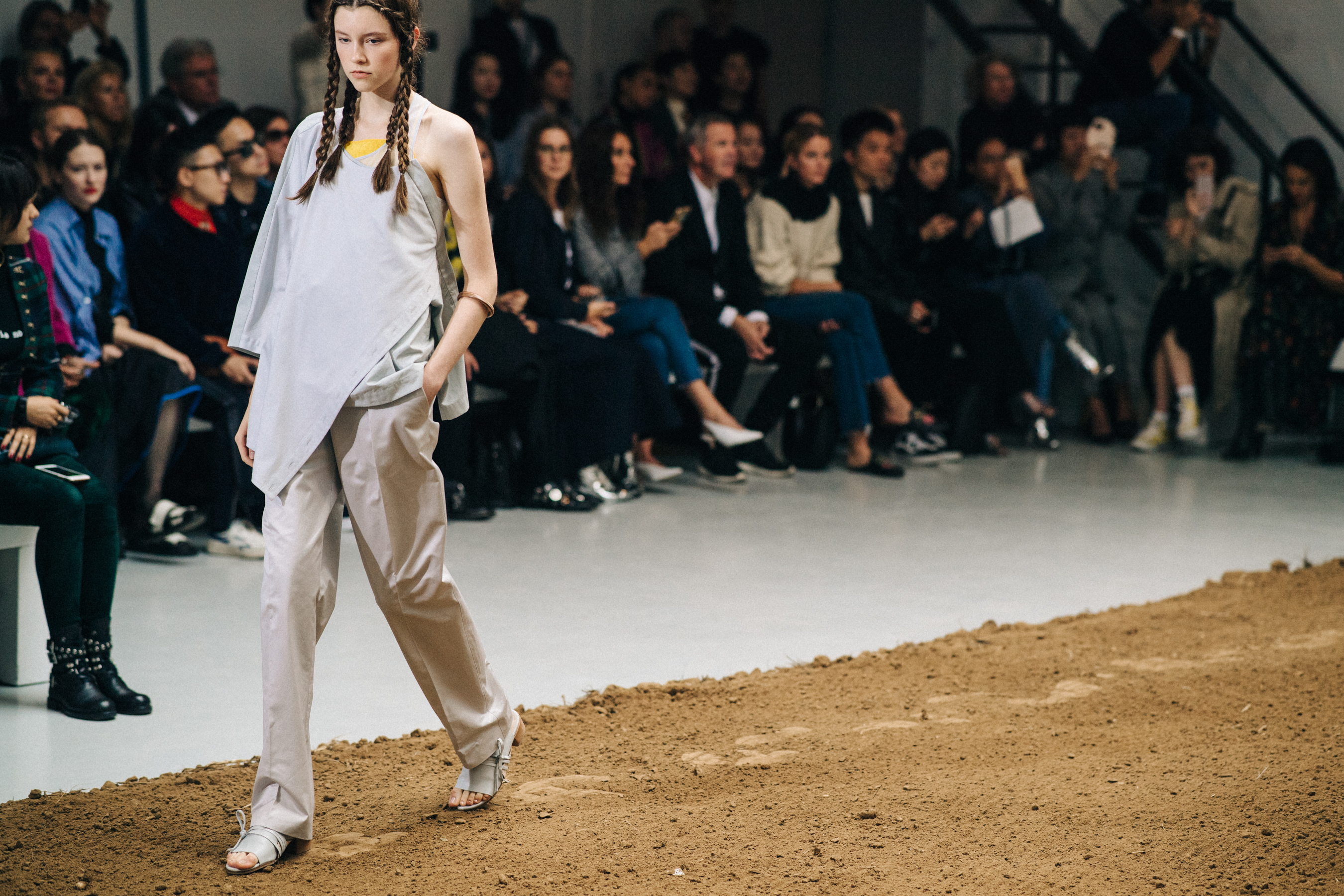 Model walking the sandy runway