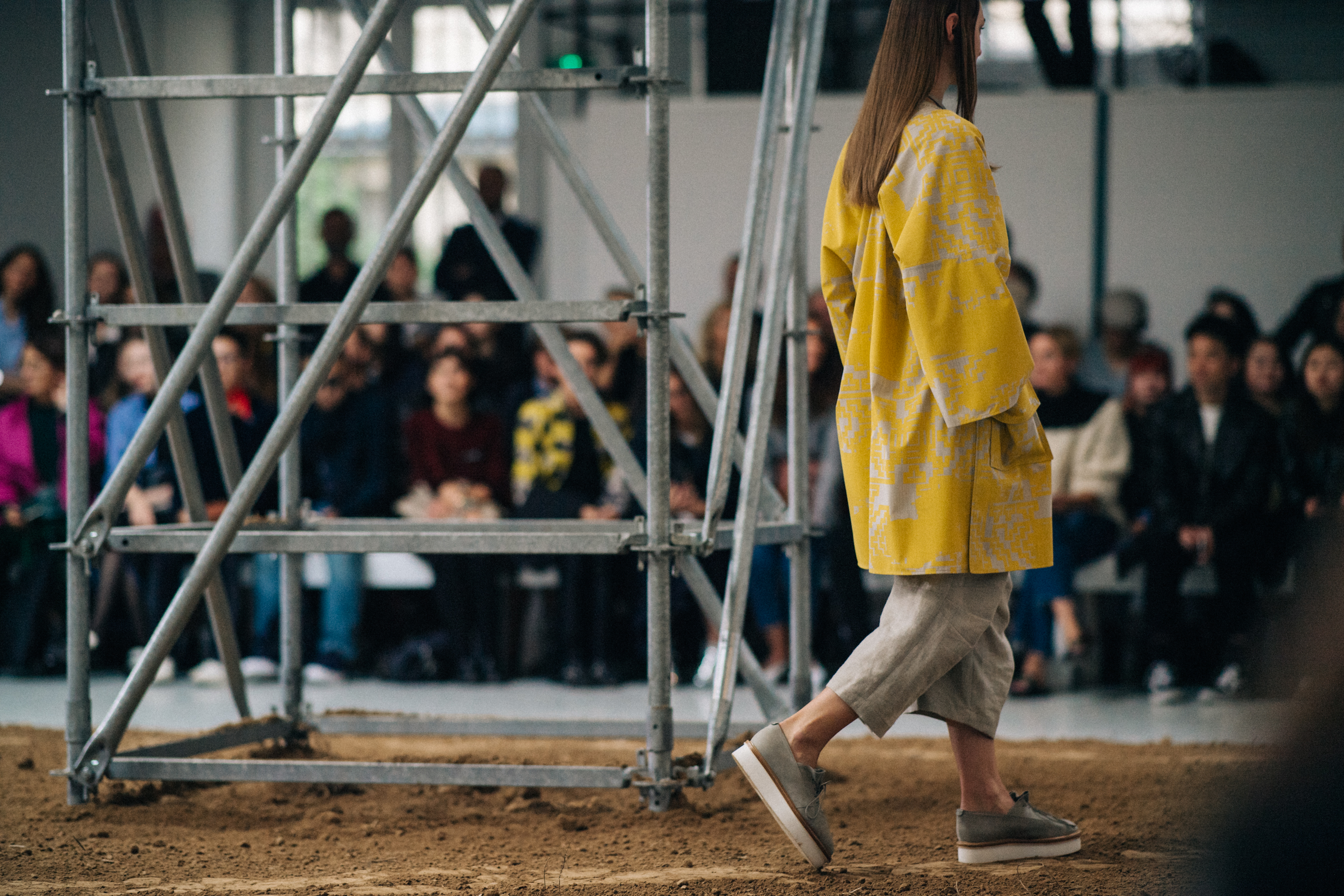 Model walking the sandy runway
