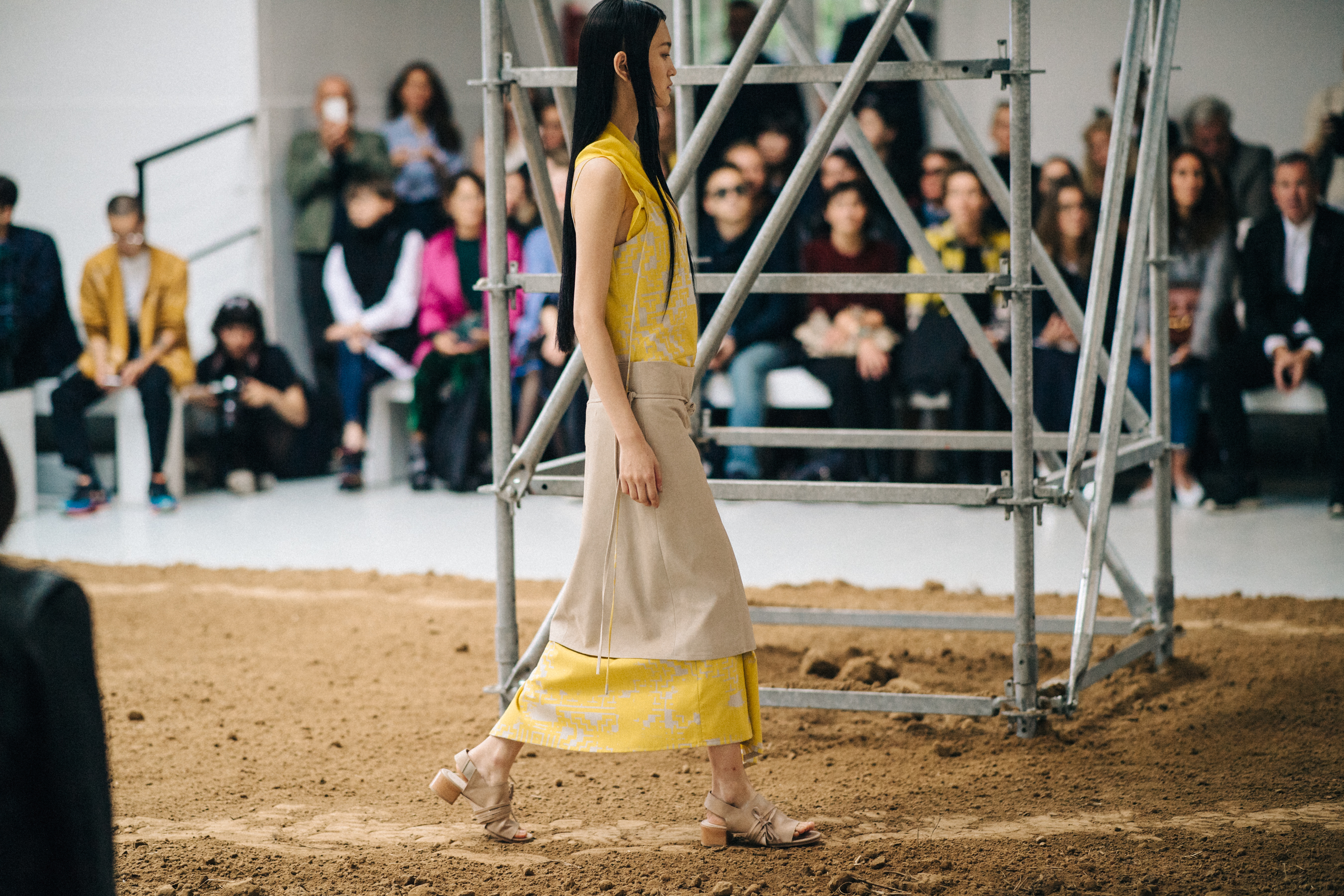 Model walking the sandy runway