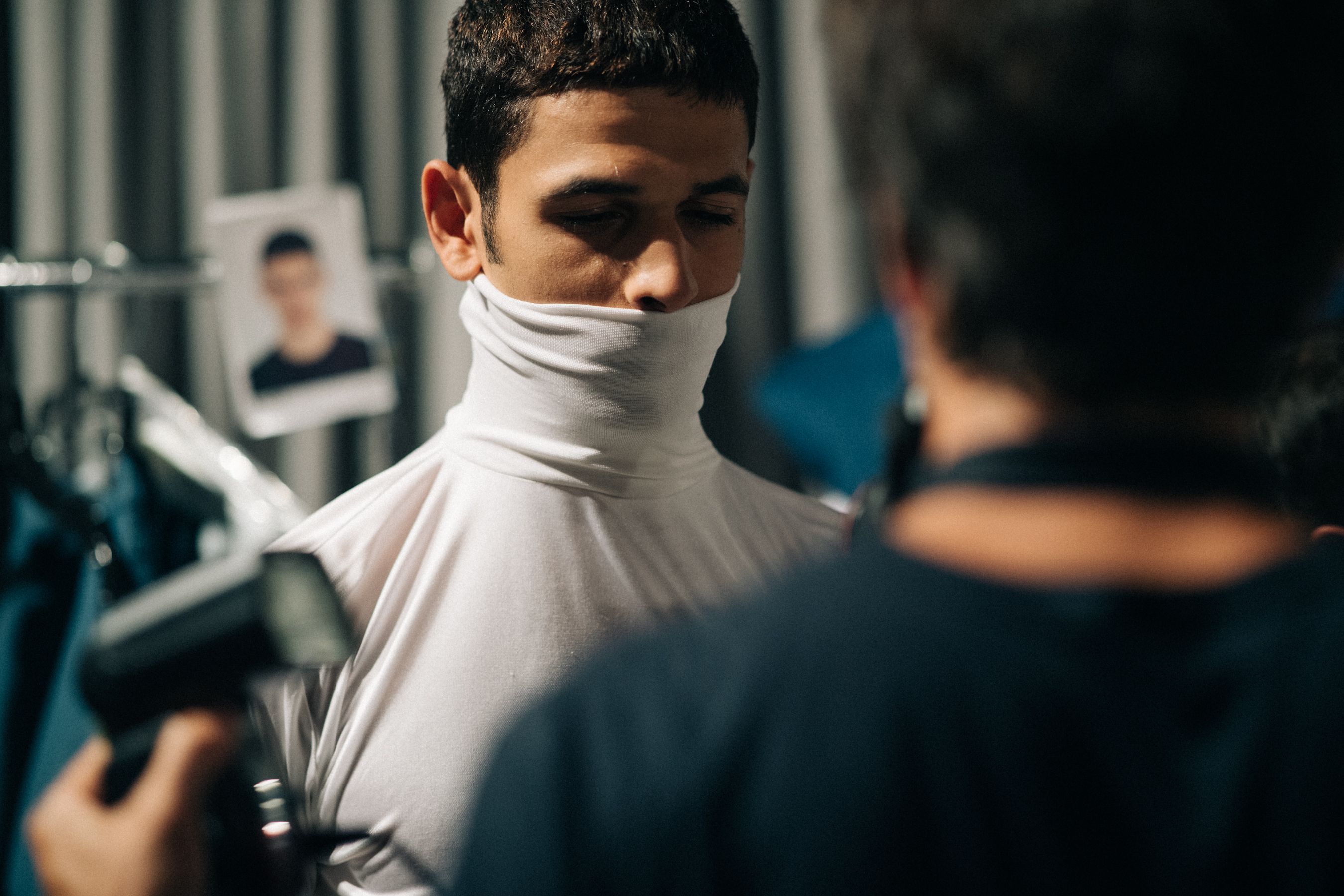 Male model wearing white turtle neck