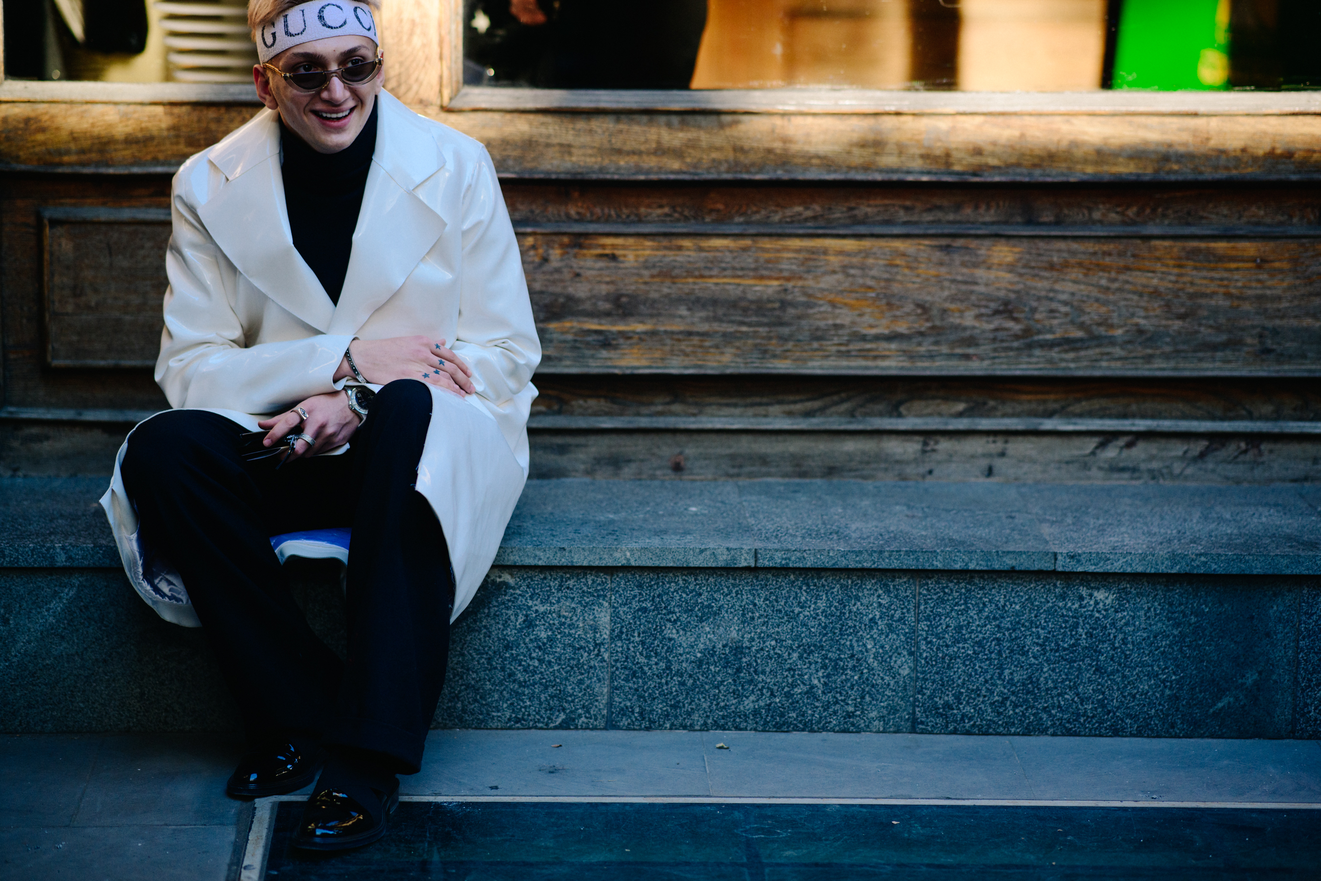 Man wearing white patent jacket