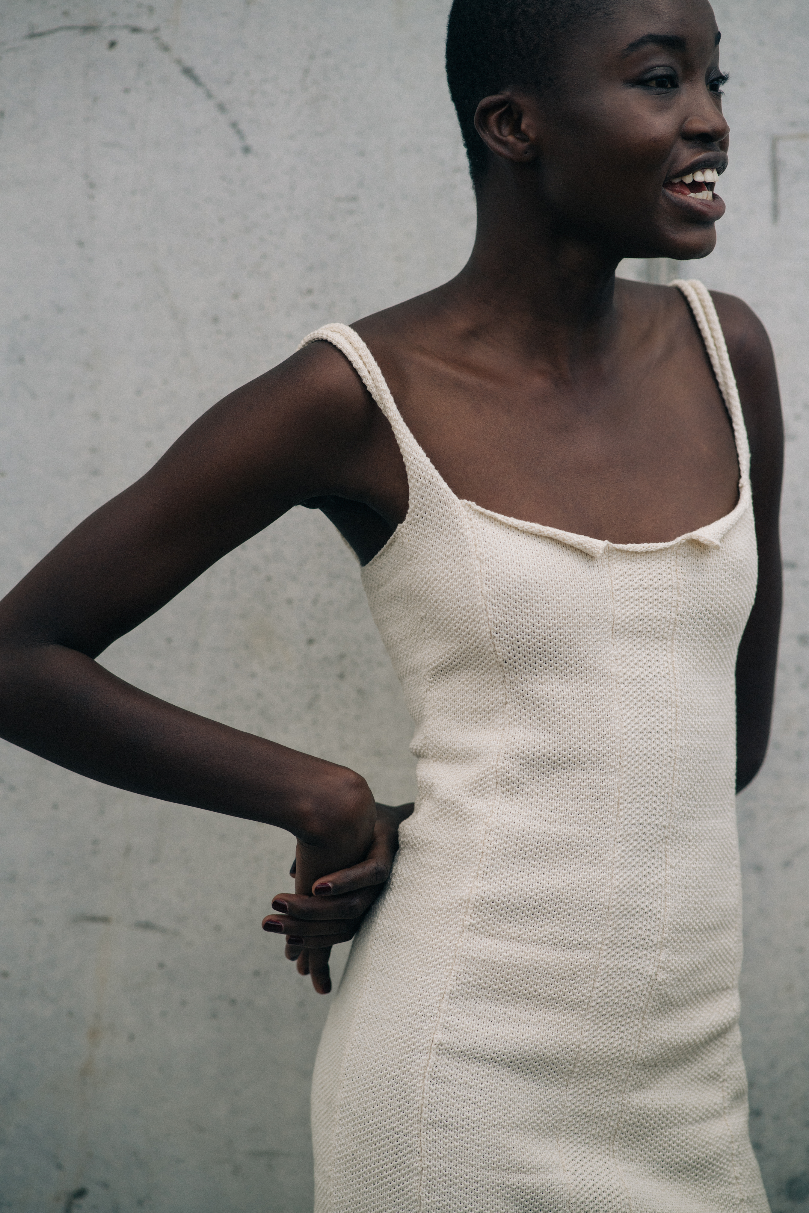 Model wearing open white dress