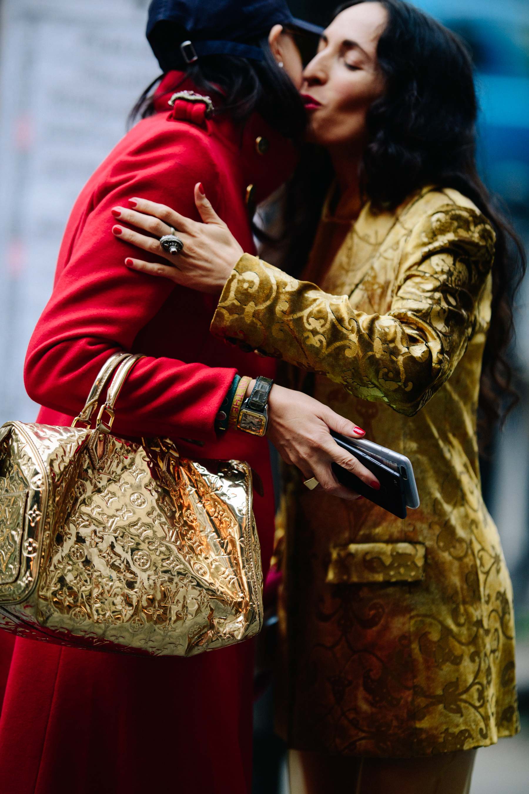 Women hugging in black and gold