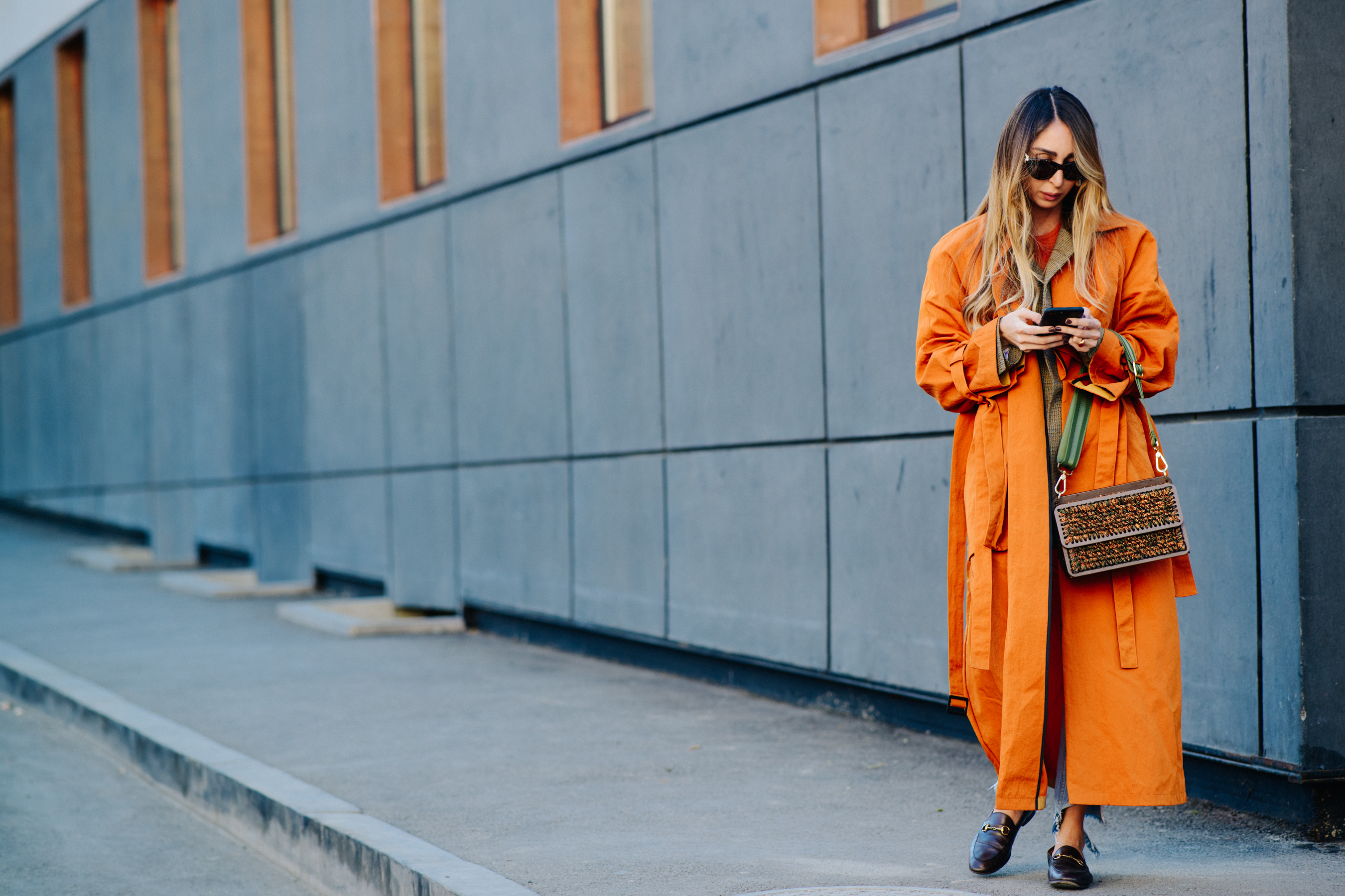 Woman wearing long orange coat