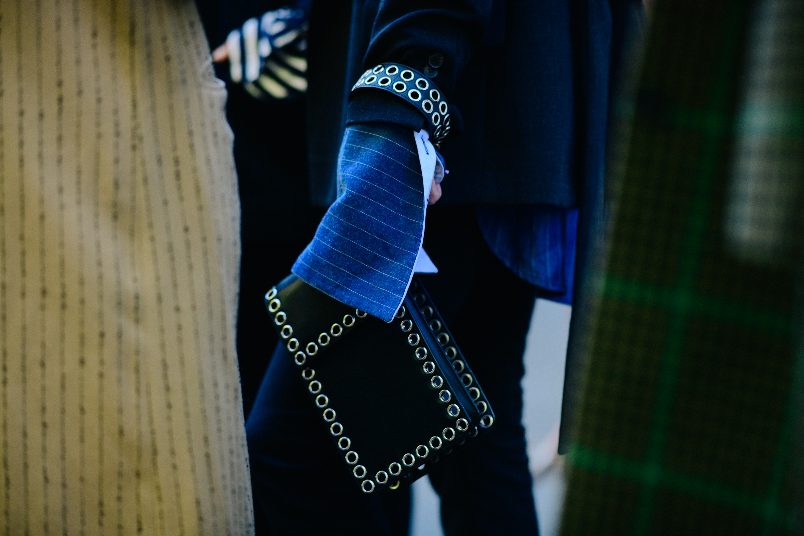 Man holding black leather bag