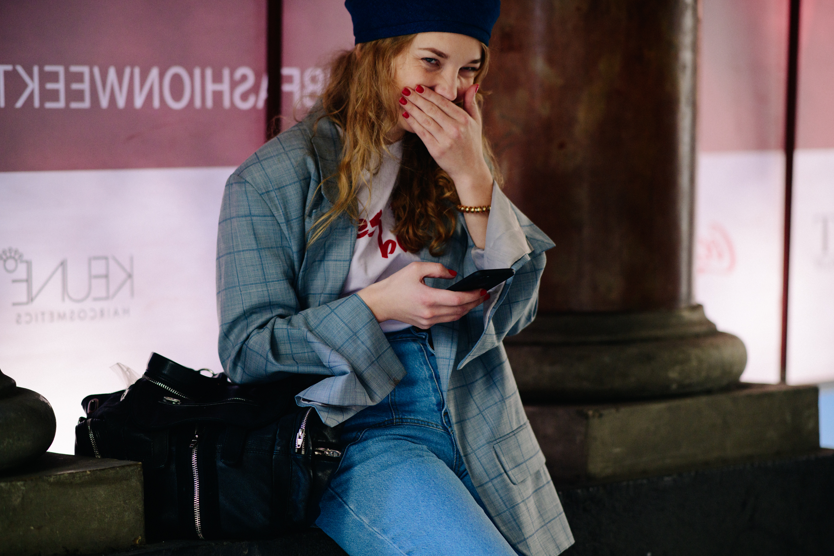 Girl laughing in grey coat