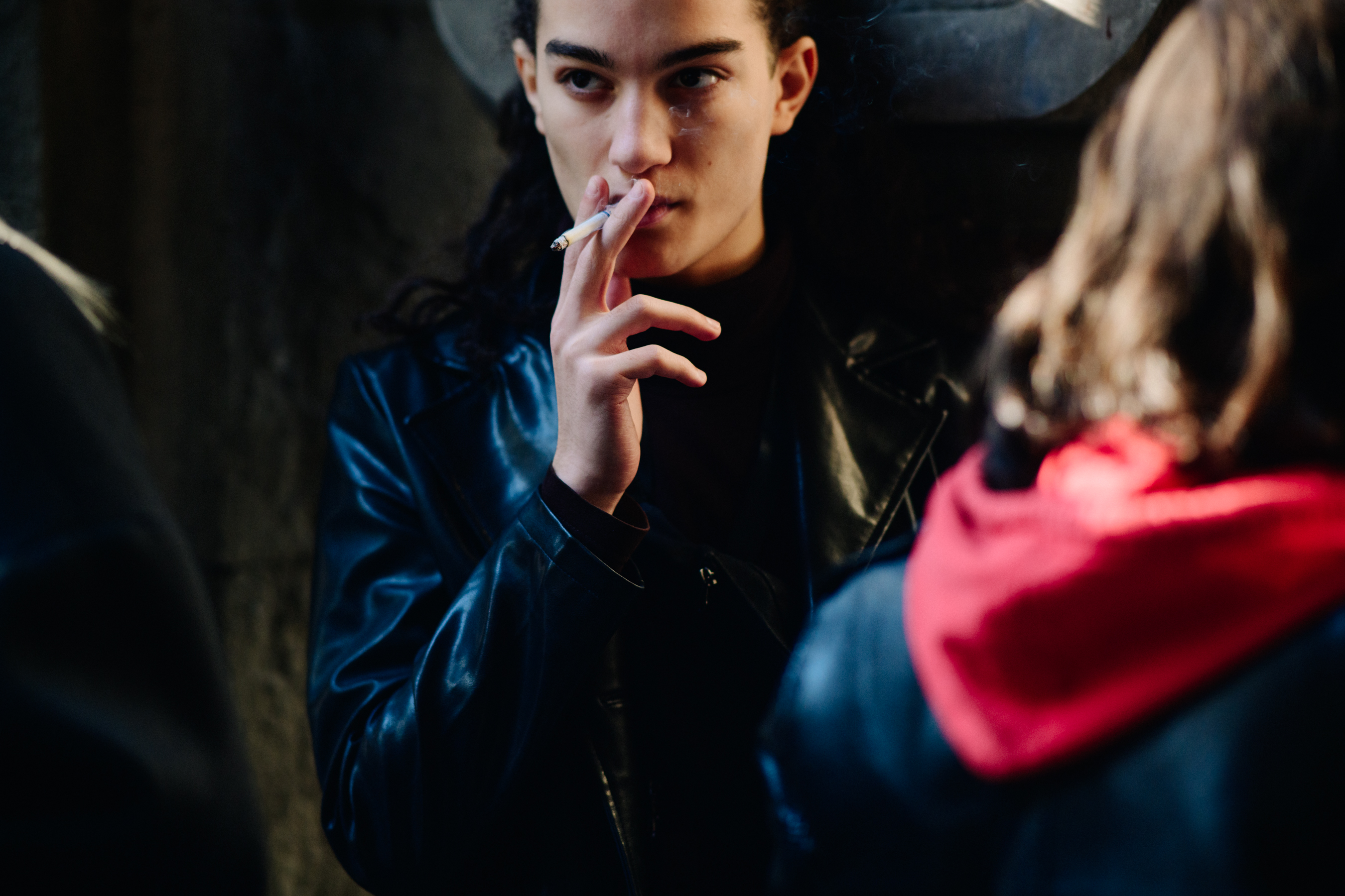 Man smoking cigarette in leather