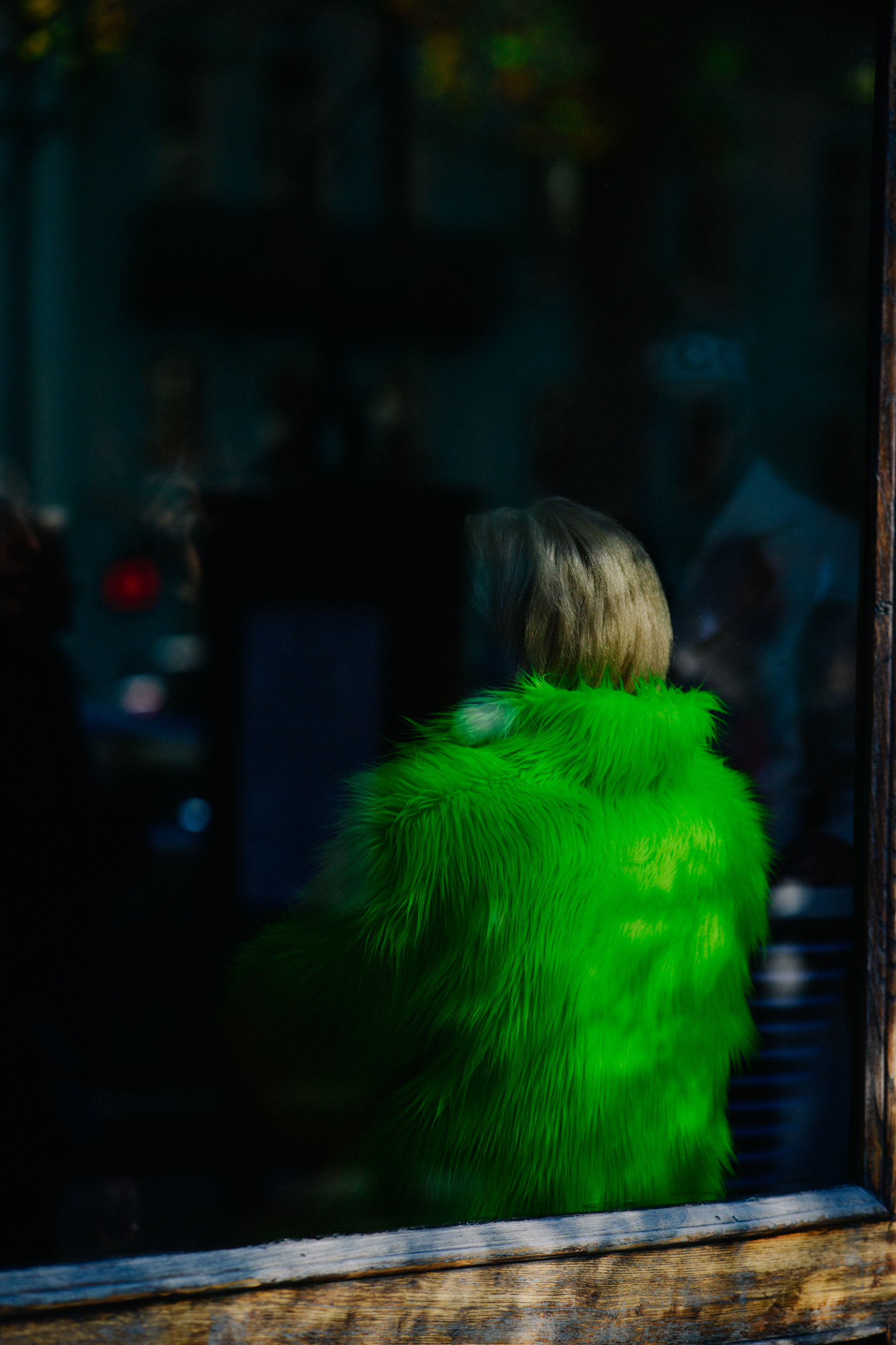 Woman wearing bright green coat