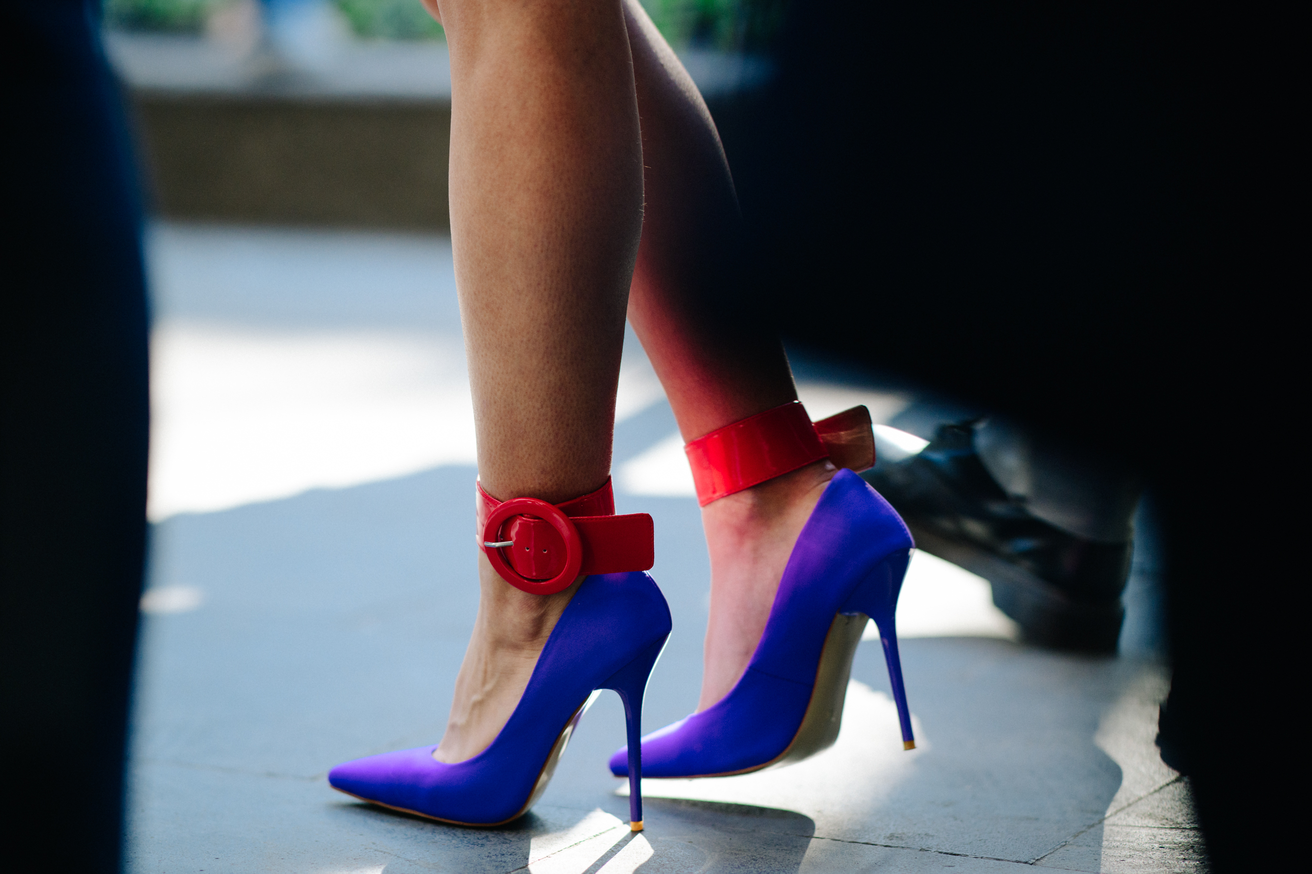 Girl wearing blue and red heels