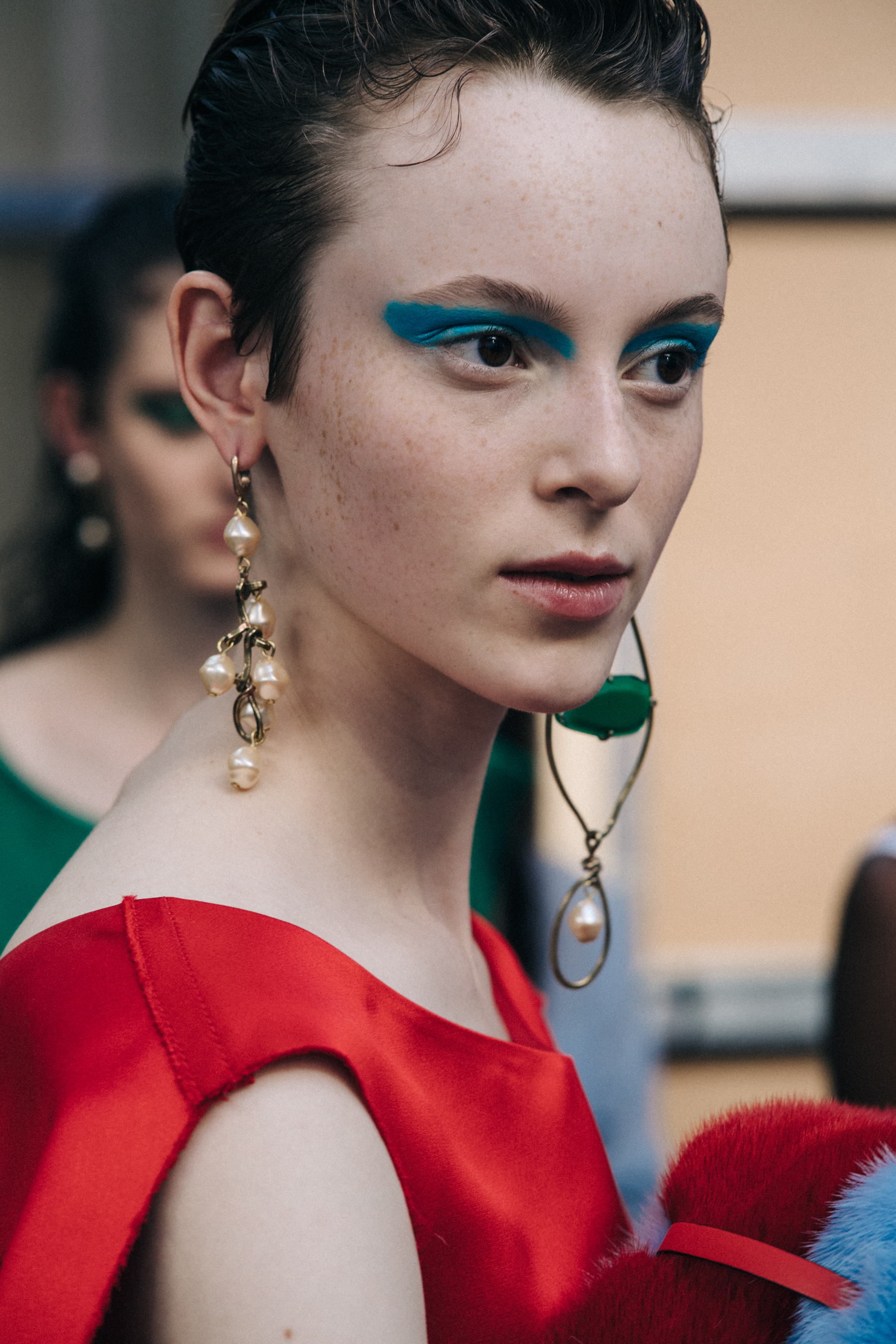 Model backstage with blue eye makeup