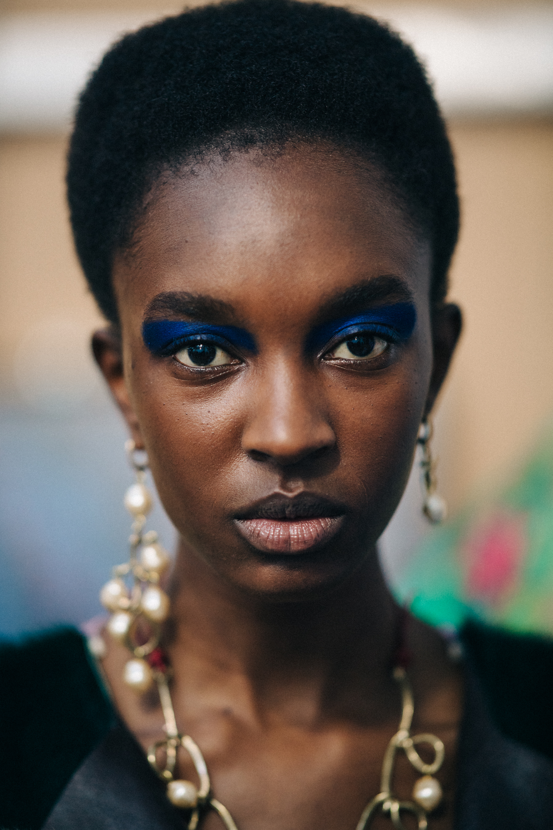 Portrait of black model wearing blue eye makeup