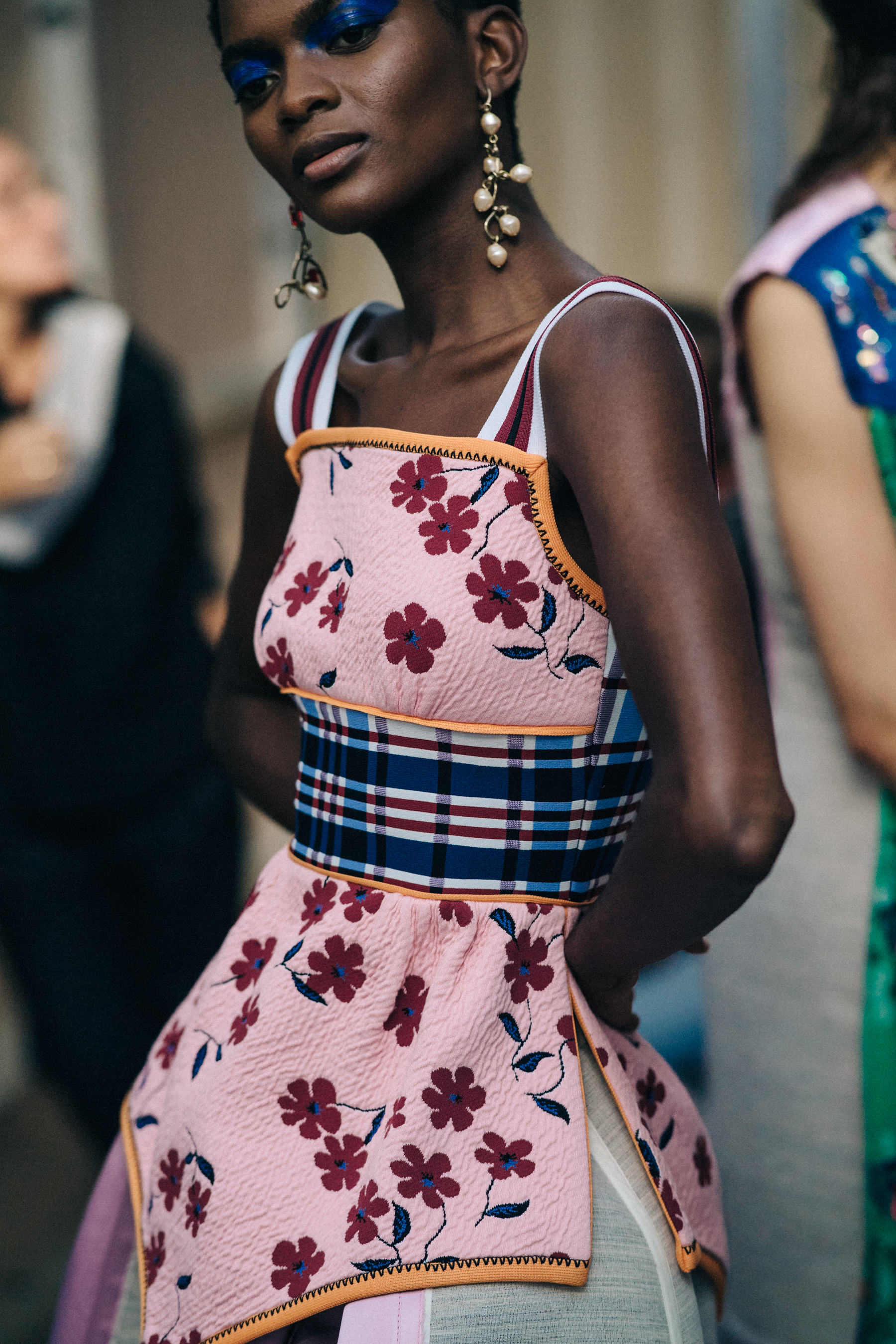 Model backstage in pink floral outfit