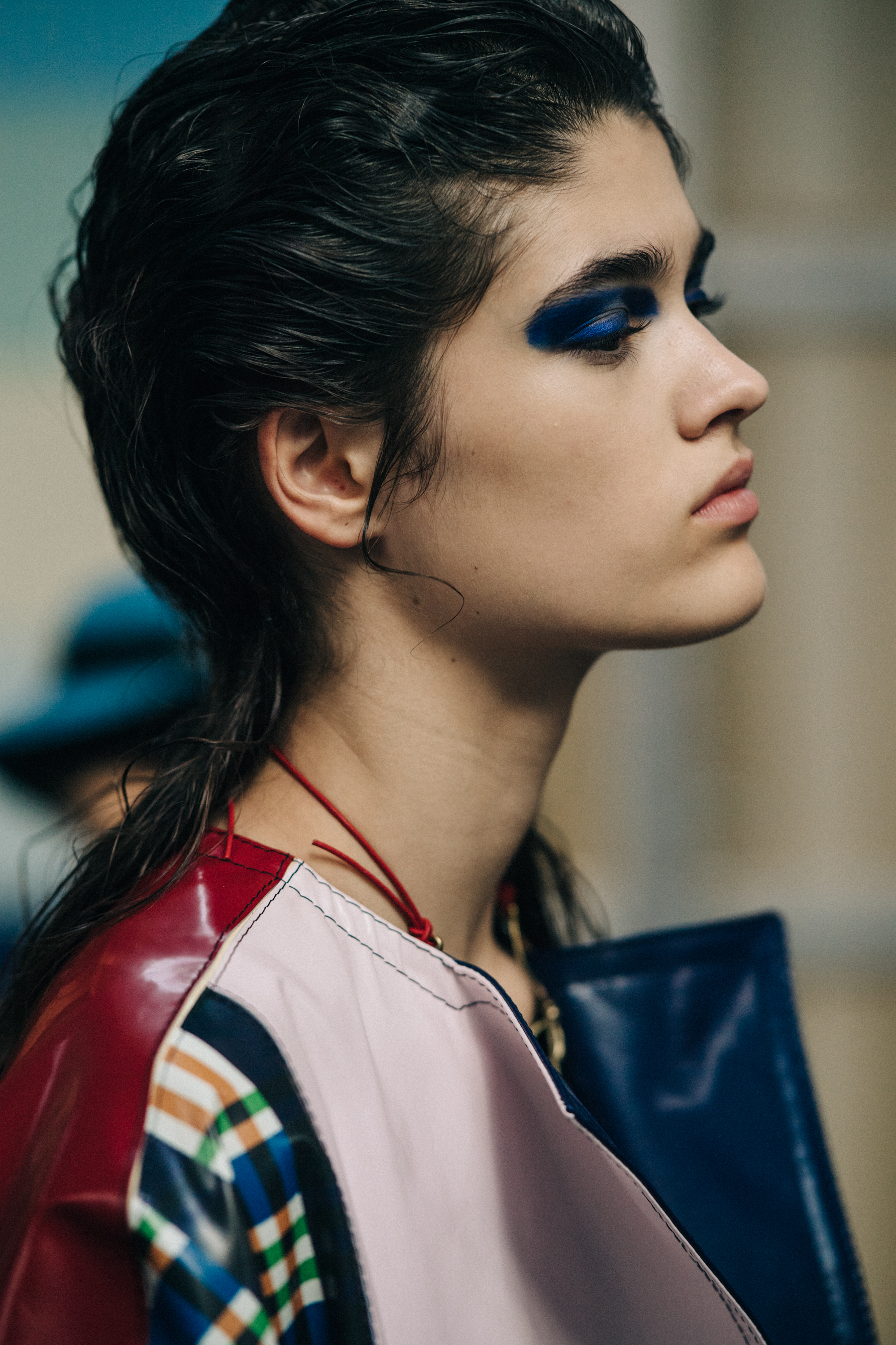 Model backstage with blue eye makeup