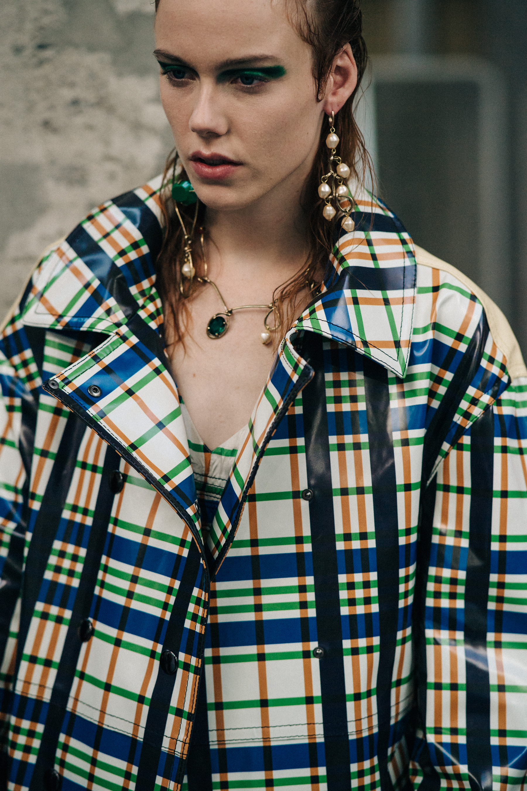 Model backstage wearing check coat