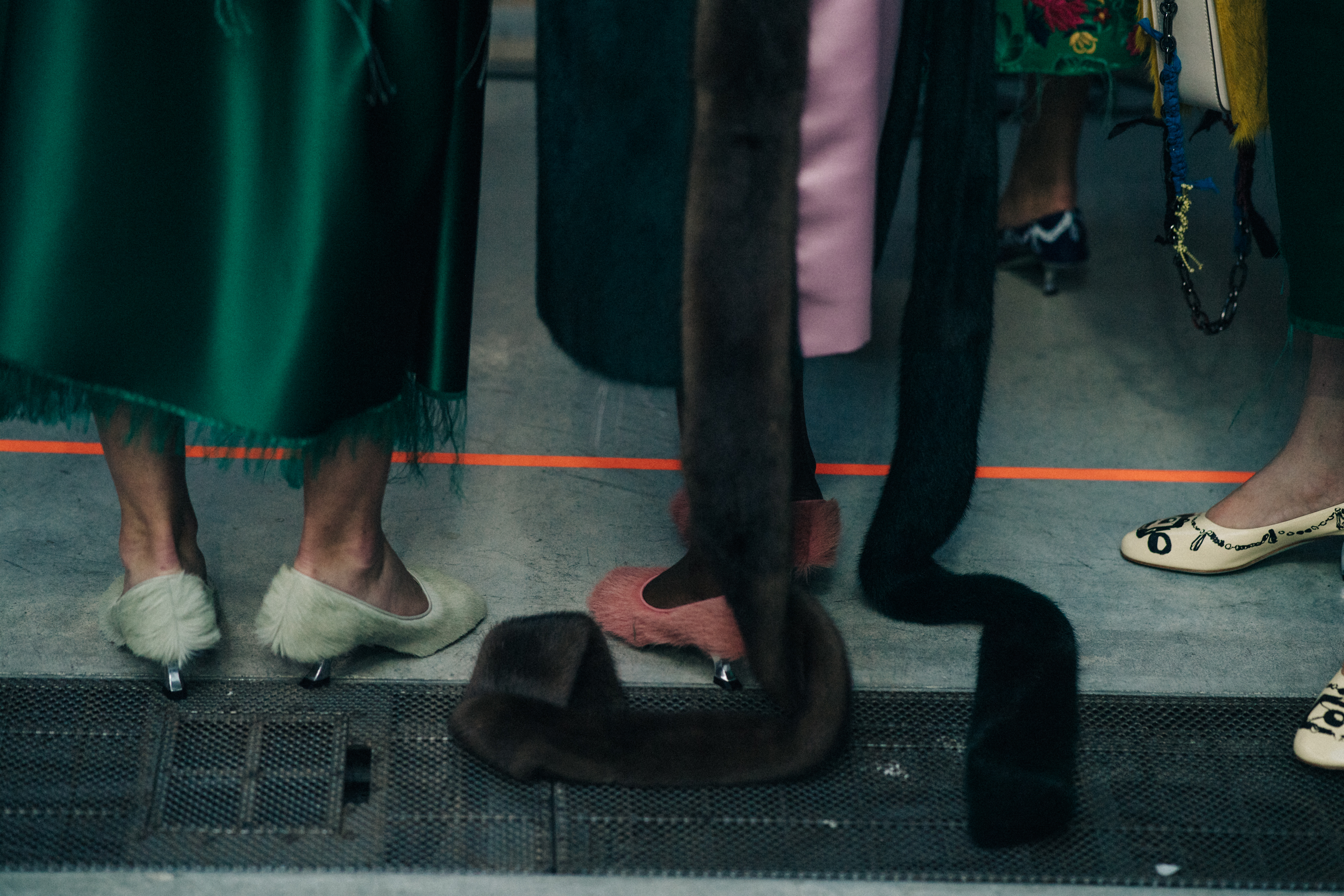 Closeup of models backstage in fur outfits