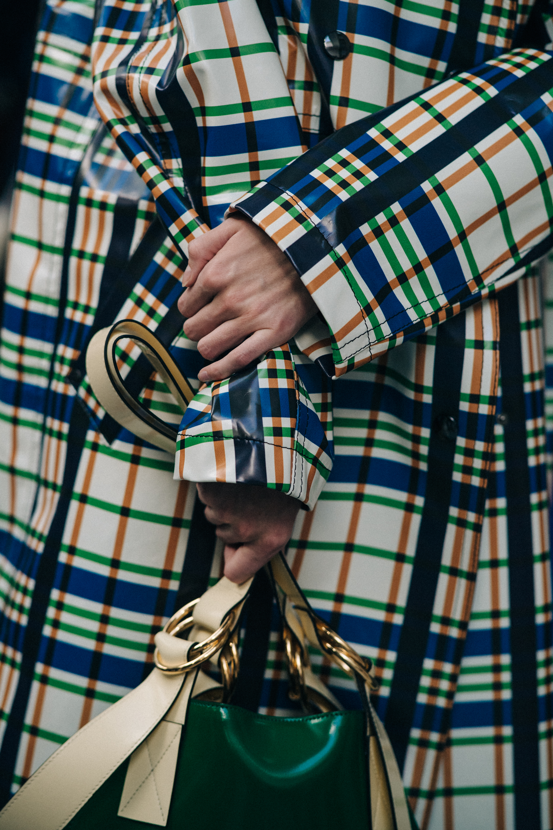 Closeup of model in coloured check coat